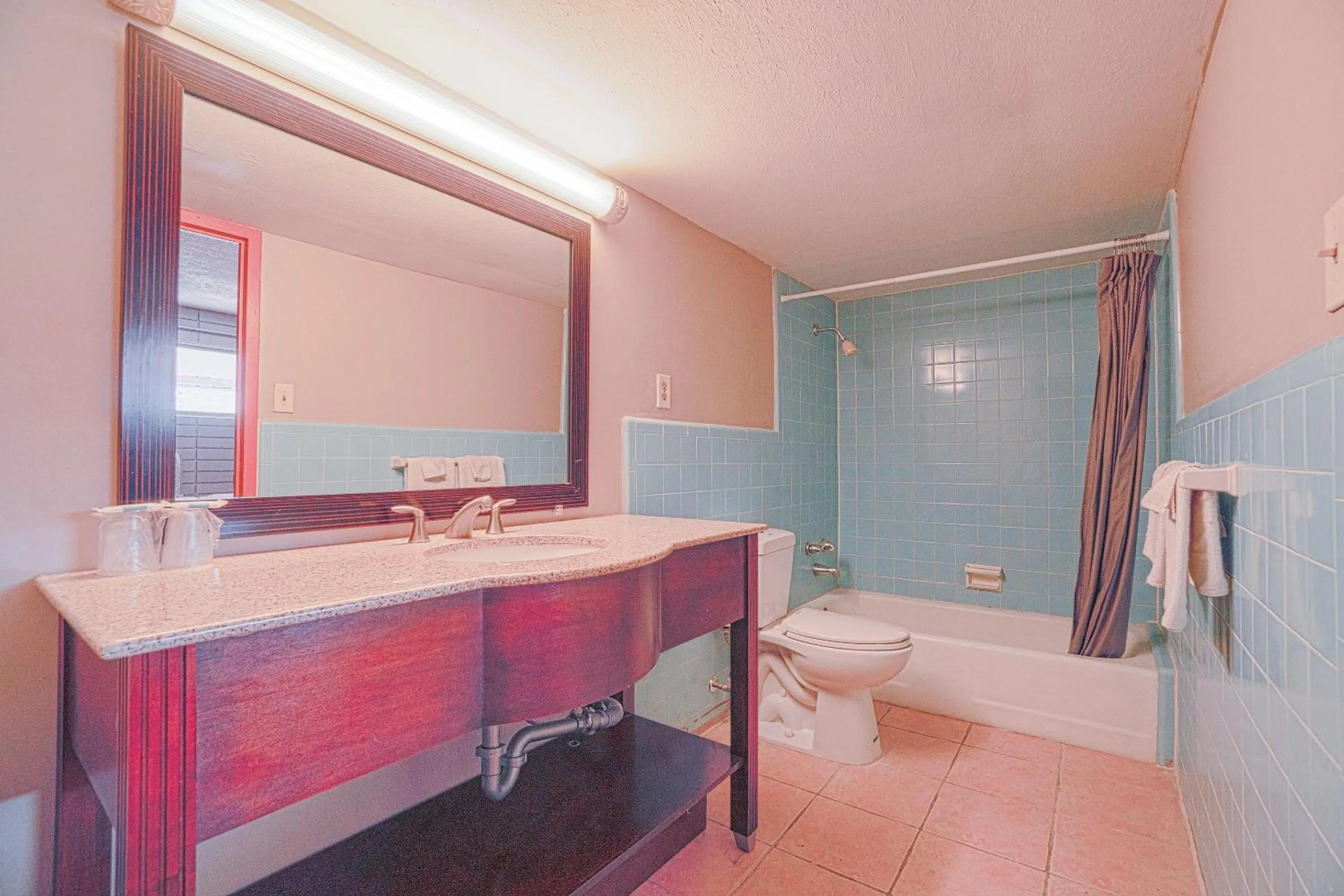 Bathroom in Town & Country Motel Bossier City by OYO