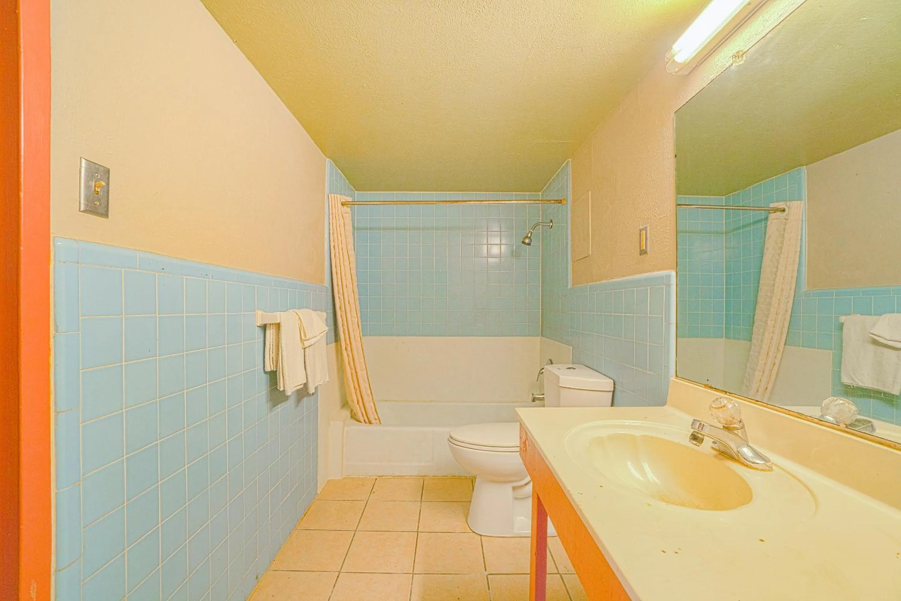Bathroom in Town & Country Motel Bossier City by OYO