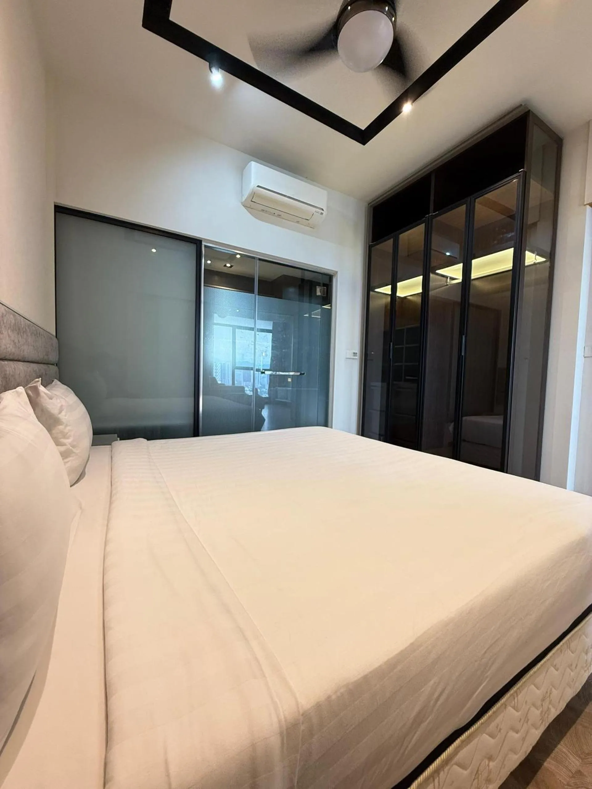 Bed in Expressionz Professional Suites by AURORA SUMMER SUITES