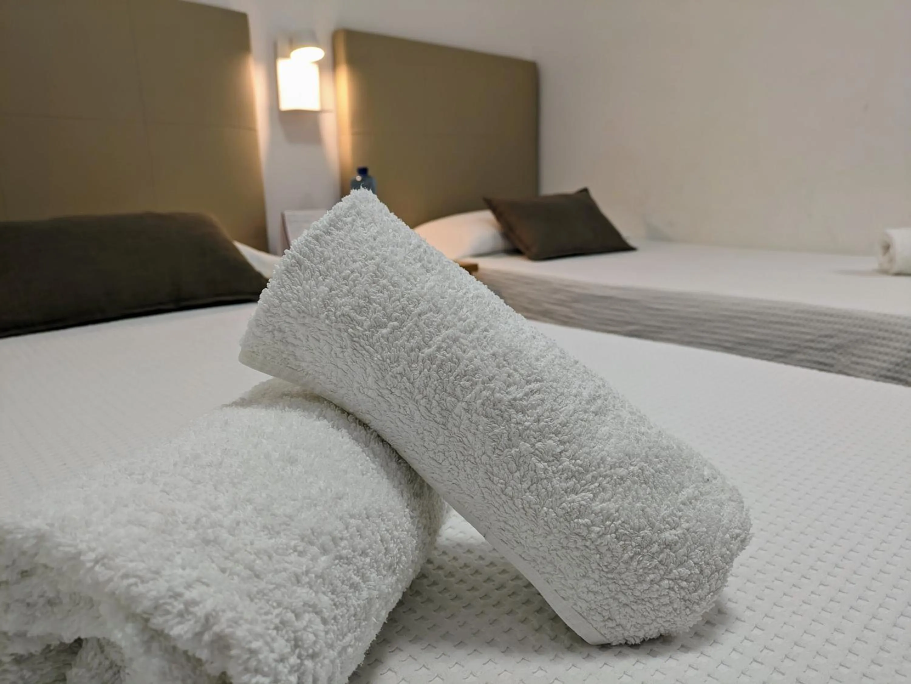 towels, Bed in Hostal Alogar