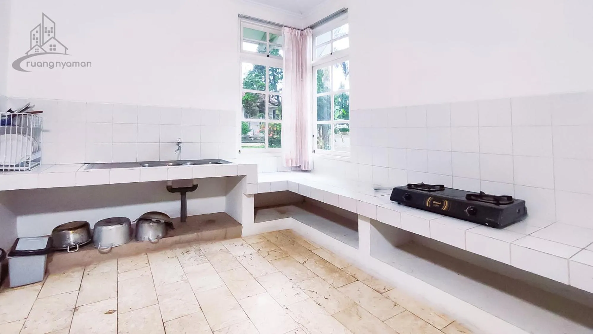 Kitchen or kitchenette in Sukanagalih Resort by Ruang Nyaman