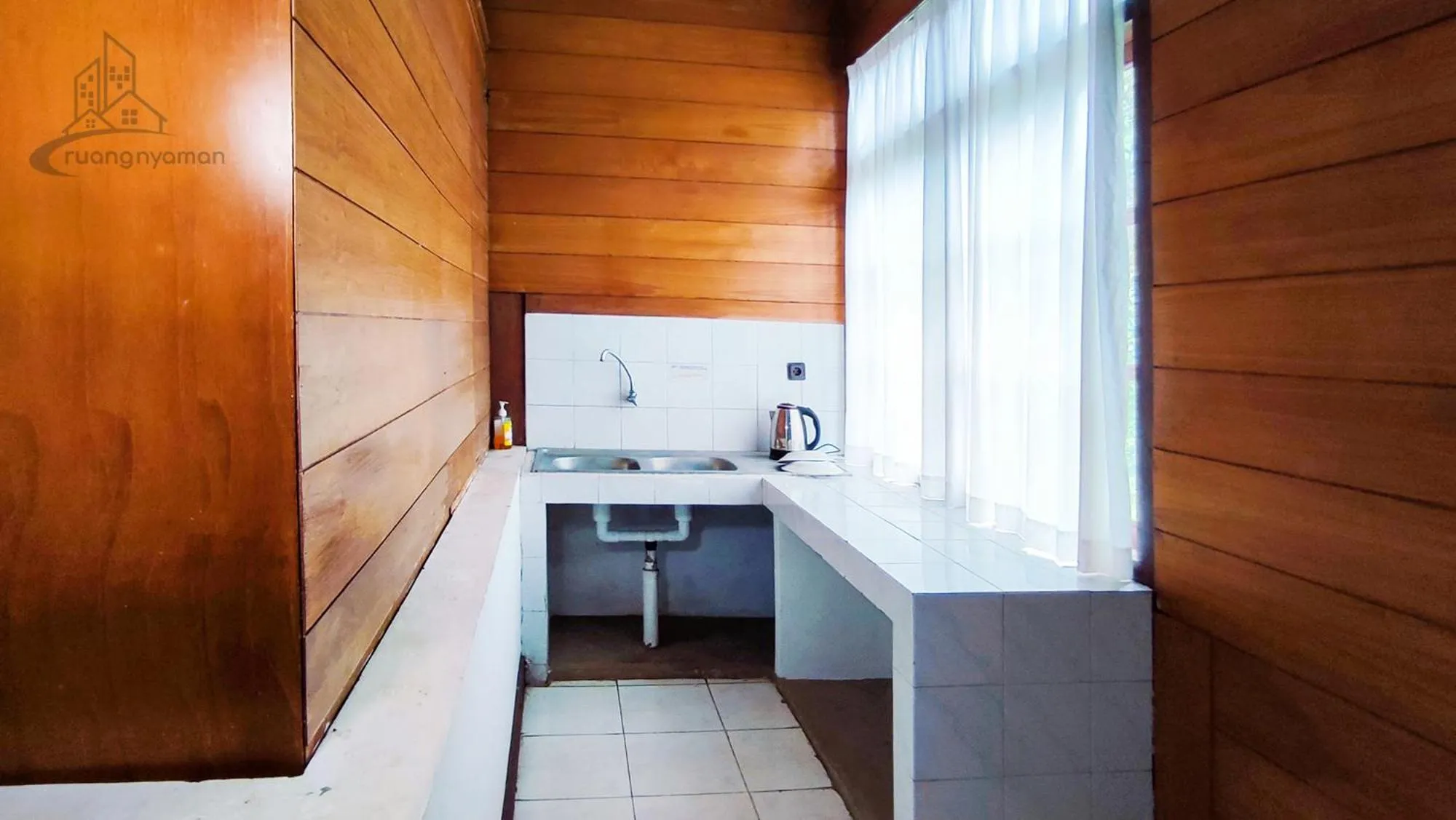 Kitchen or kitchenette in Sukanagalih Resort by Ruang Nyaman