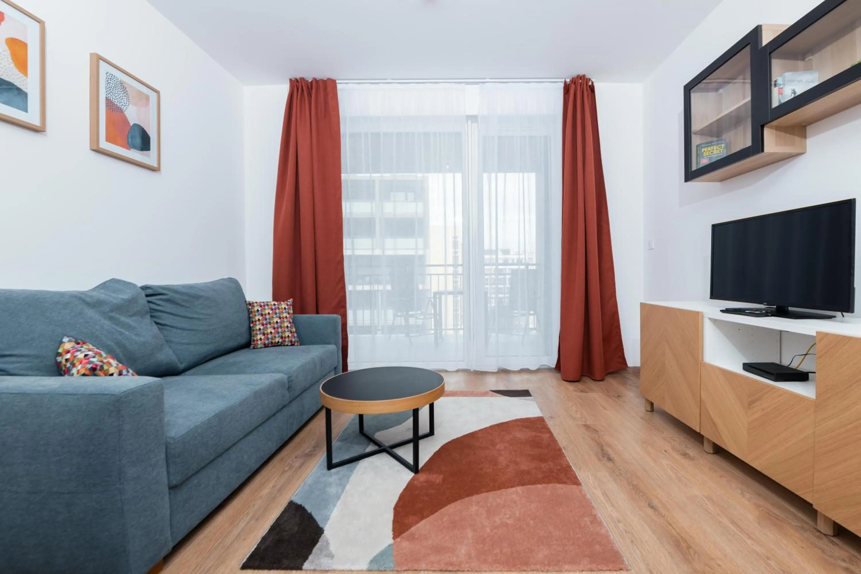 Communal lounge/ TV room in WestSide Apartments by FirstHost