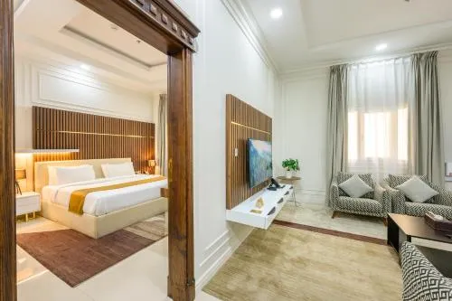 Communal lounge/ TV room, Bed in Abraj Royal Hotel
