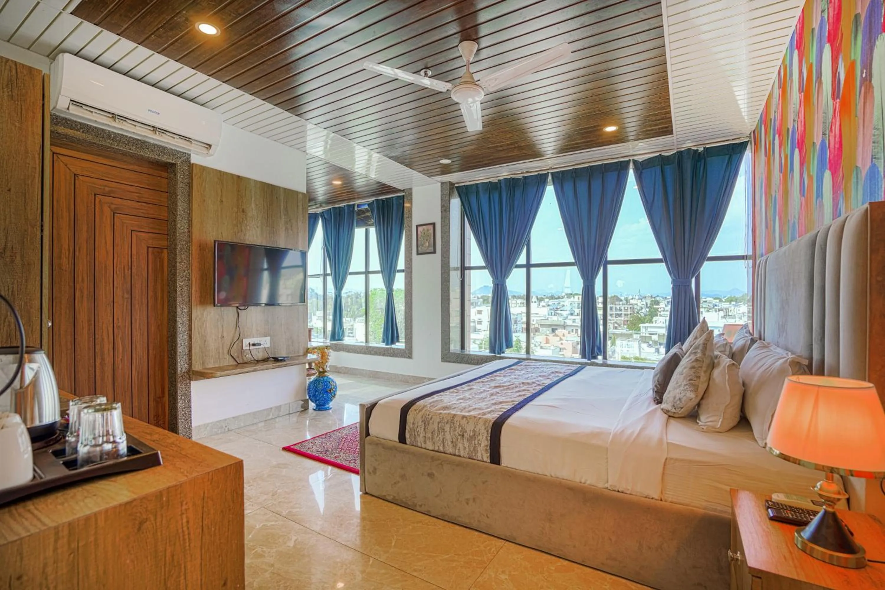 Photo of the whole room, Bed in Pax Hotel Grand Blue 3 min walk from Udaipur city Railway Station