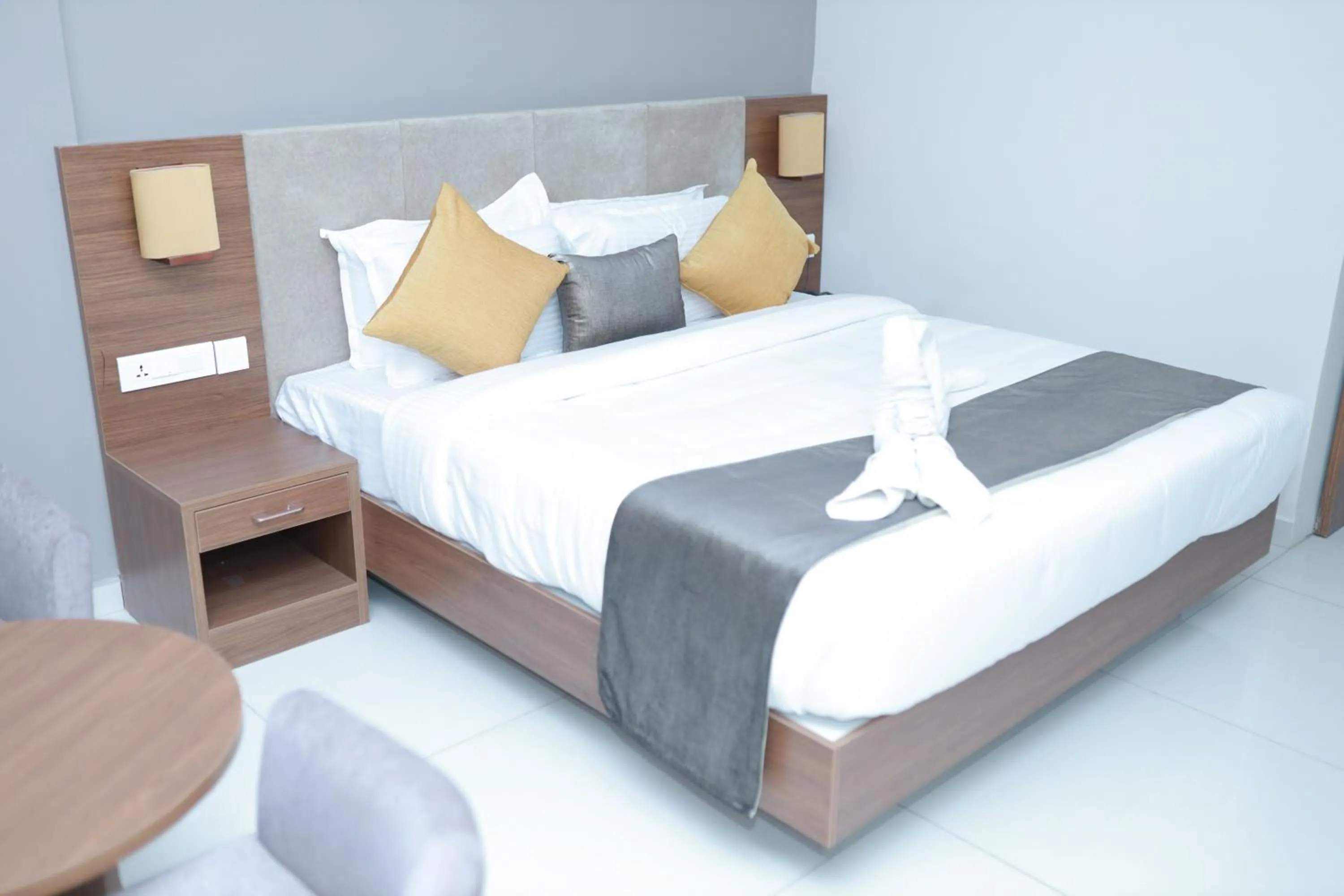 Bed in Hotel Kottayam Grand