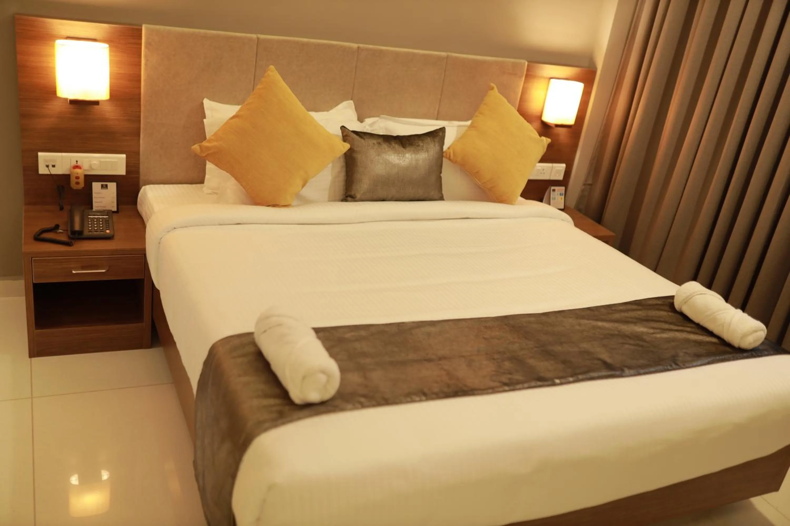 Bed in Hotel Kottayam Grand
