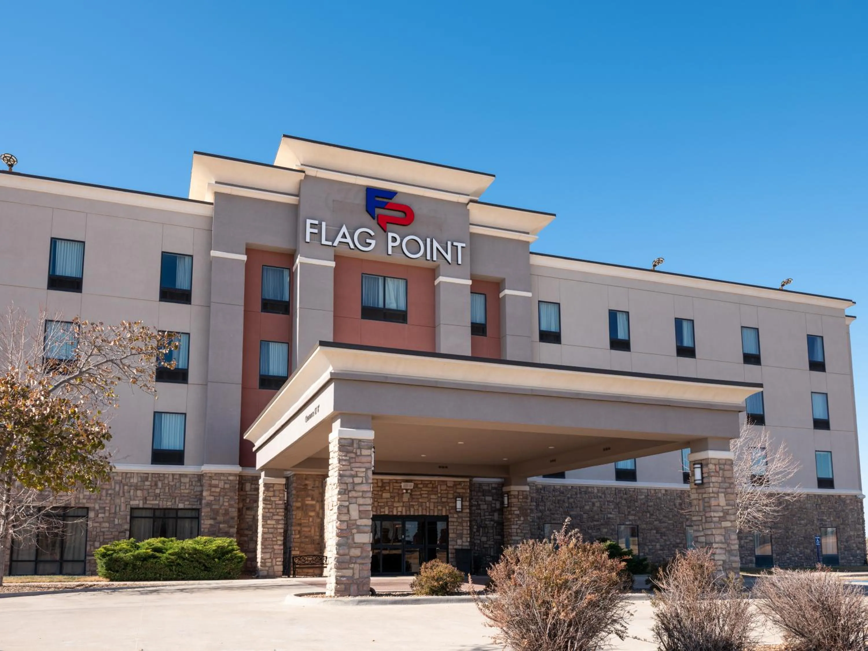 Property building in Flag Point Inn and Suites Pratt by FairBridge