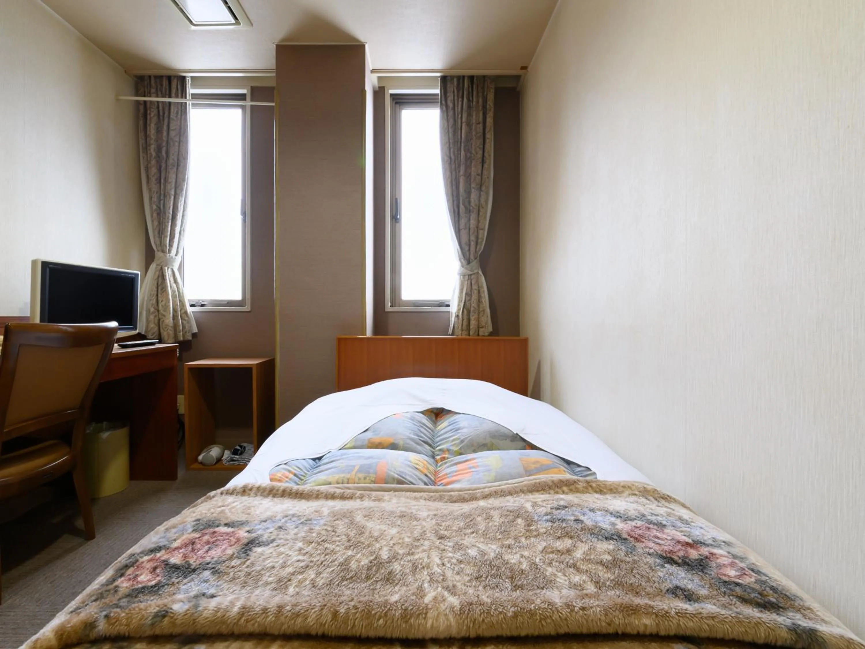 Bed in Tabist Business Ryokan Hotel Yukimiso