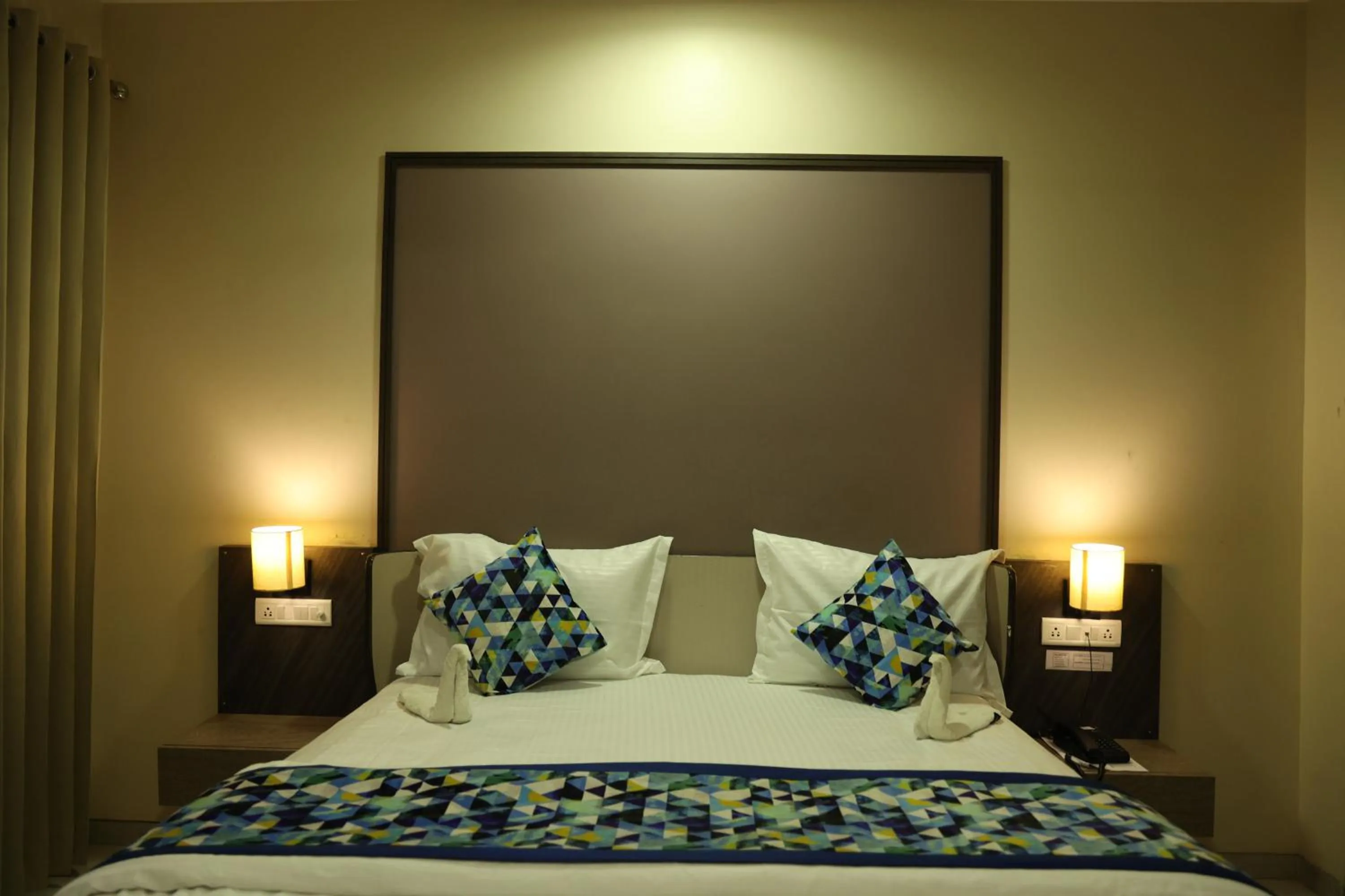 Bed in Hotel Pinaka Inn