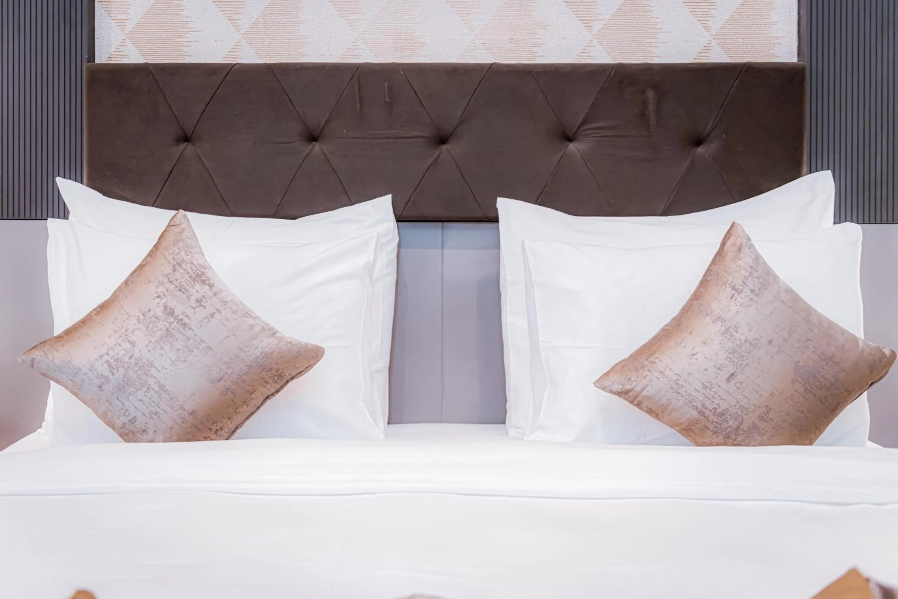 Bed in Wali's Suites