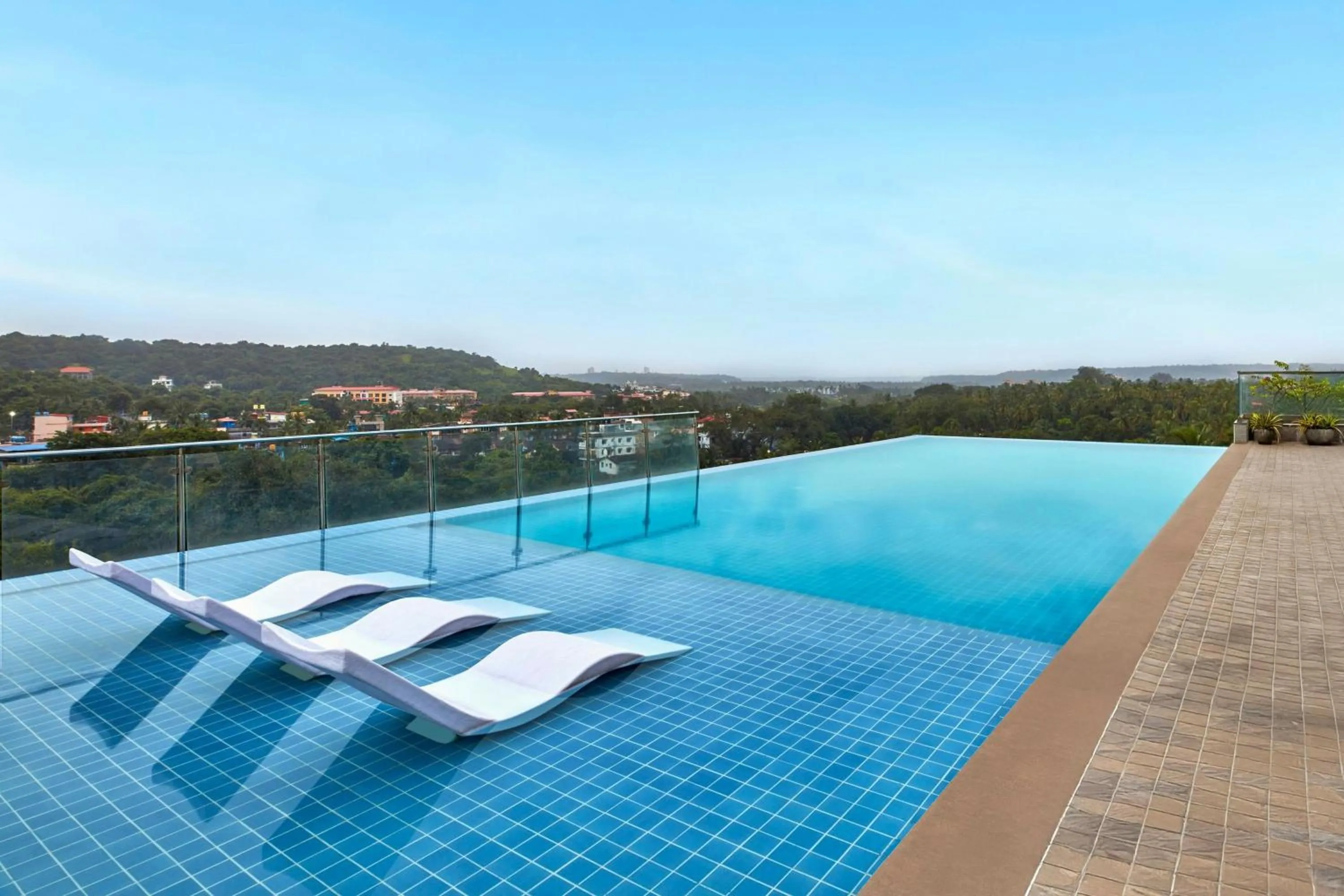 Swimming pool in The Fern Habitat Goa, Candolim, Series by Marriott