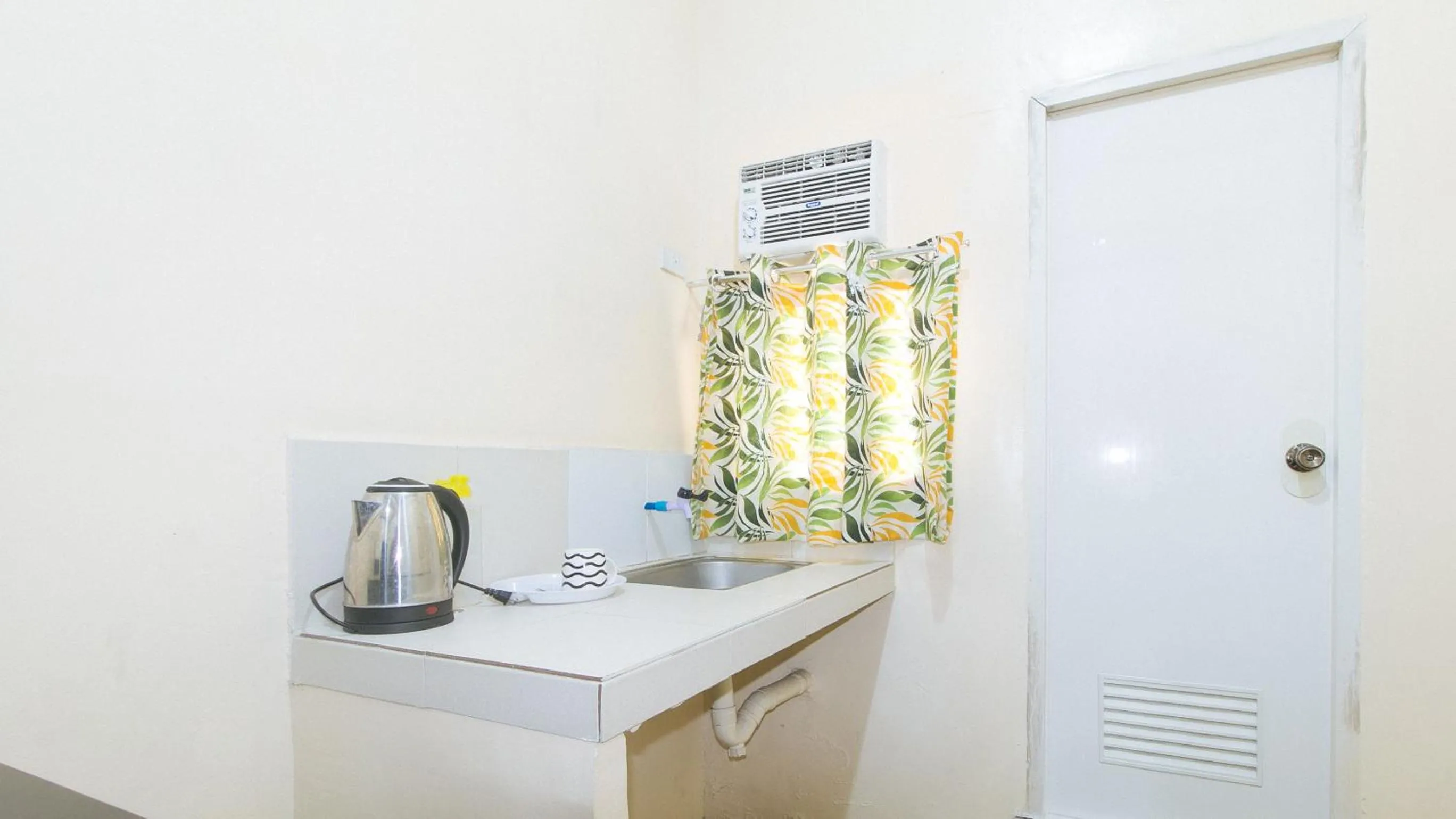 Kitchen or kitchenette in Mervin's Terraces by RedDoorz