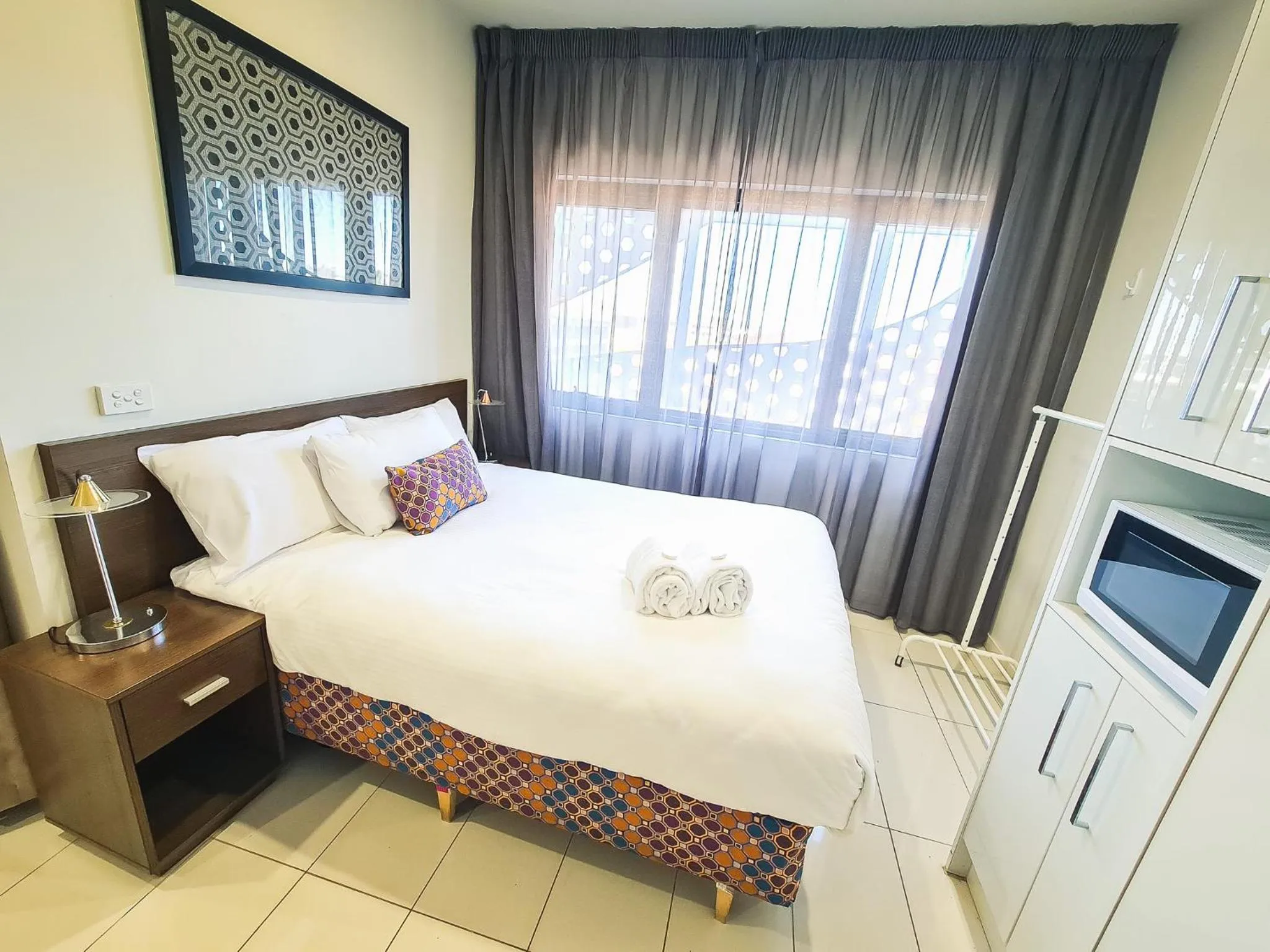 Bed in Exodus Dandenong Apartment Hotel