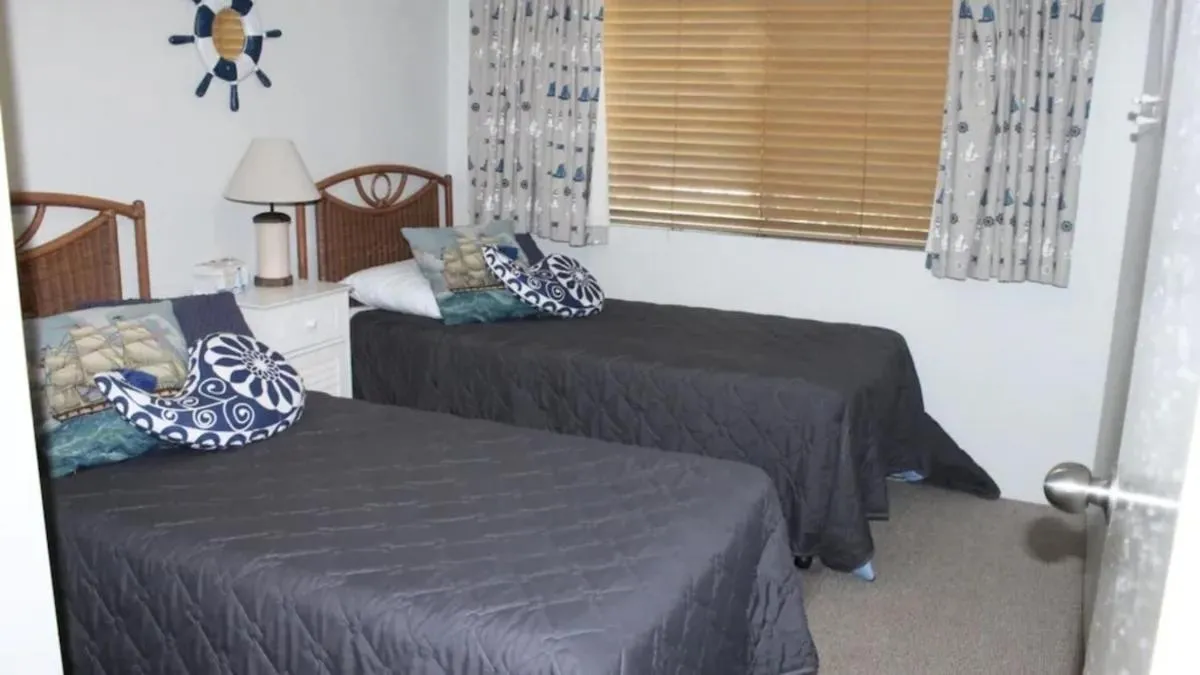 Bed in Paradise Grove Holiday Apartments