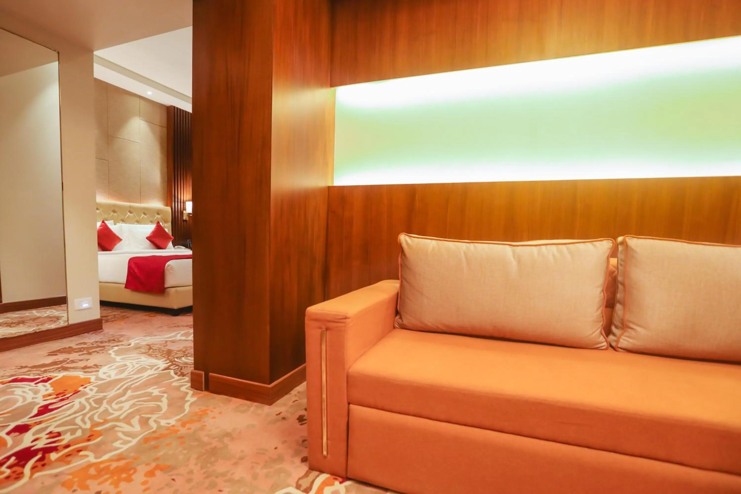 Seating area, Bed in Regenta Place Jhansi by Royal Orchid Hotels Limited