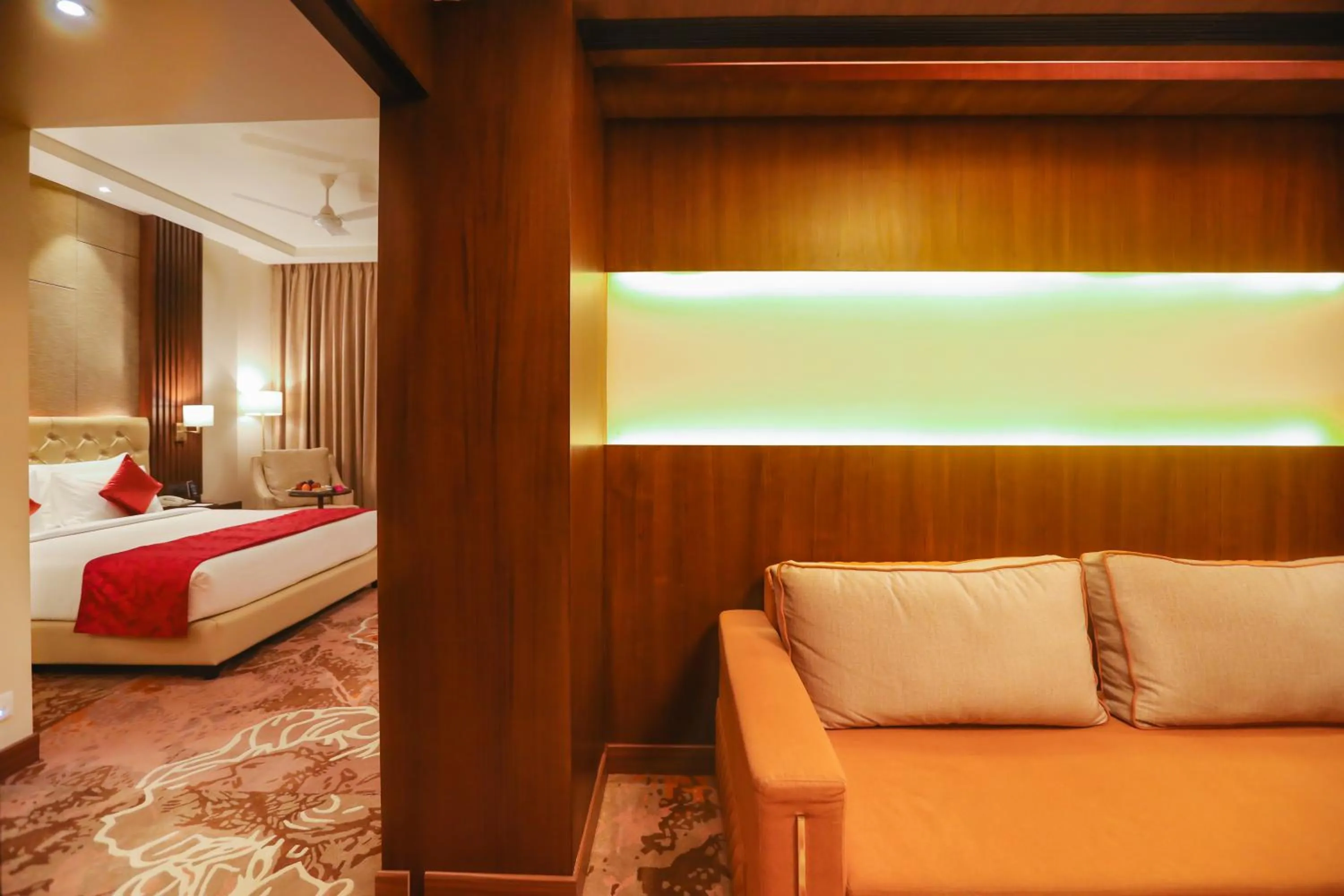 Living room, Bed in Regenta Place Jhansi by Royal Orchid Hotels Limited