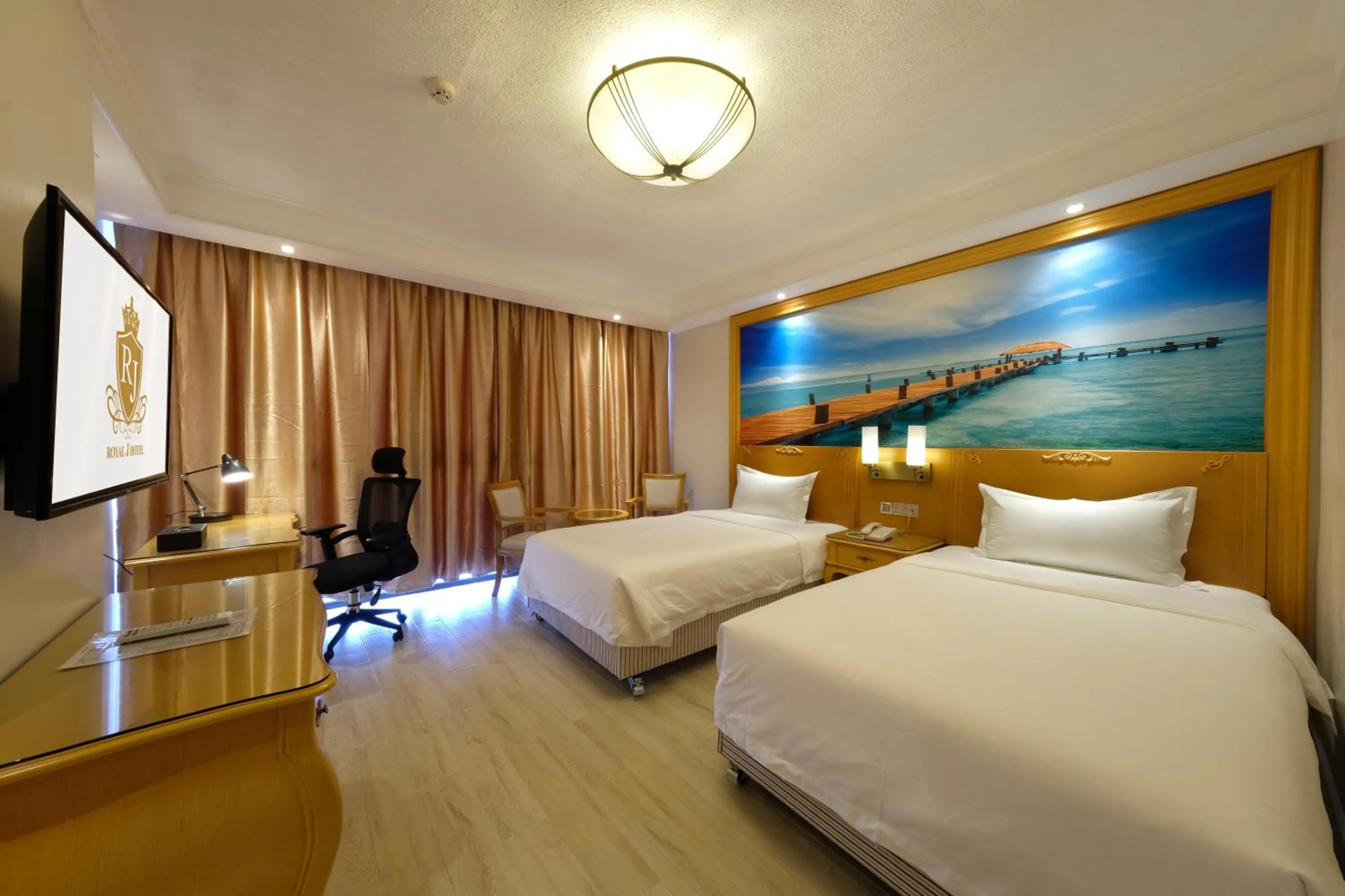 Bed in ROYAL J HOTEL