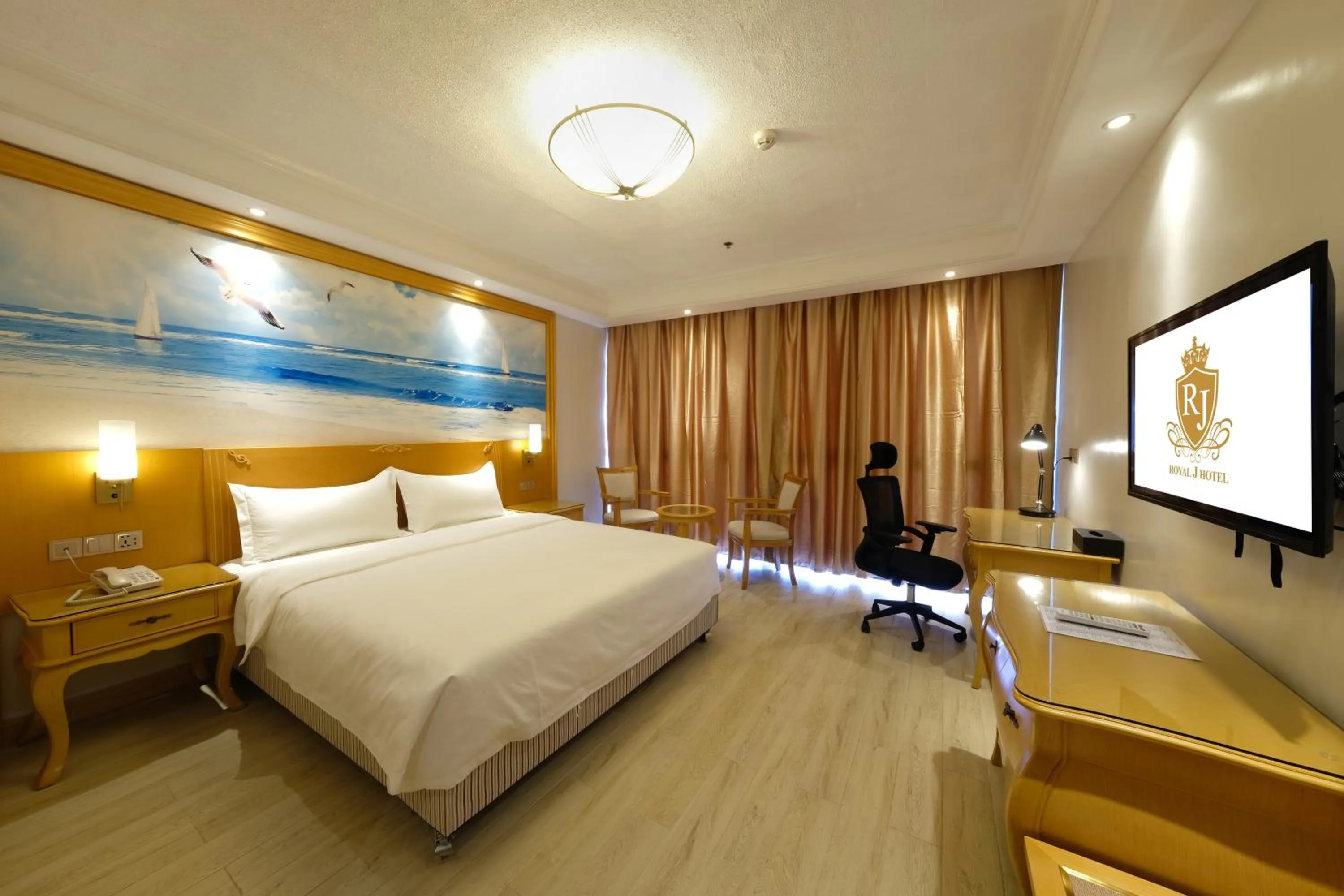 Bed in ROYAL J HOTEL