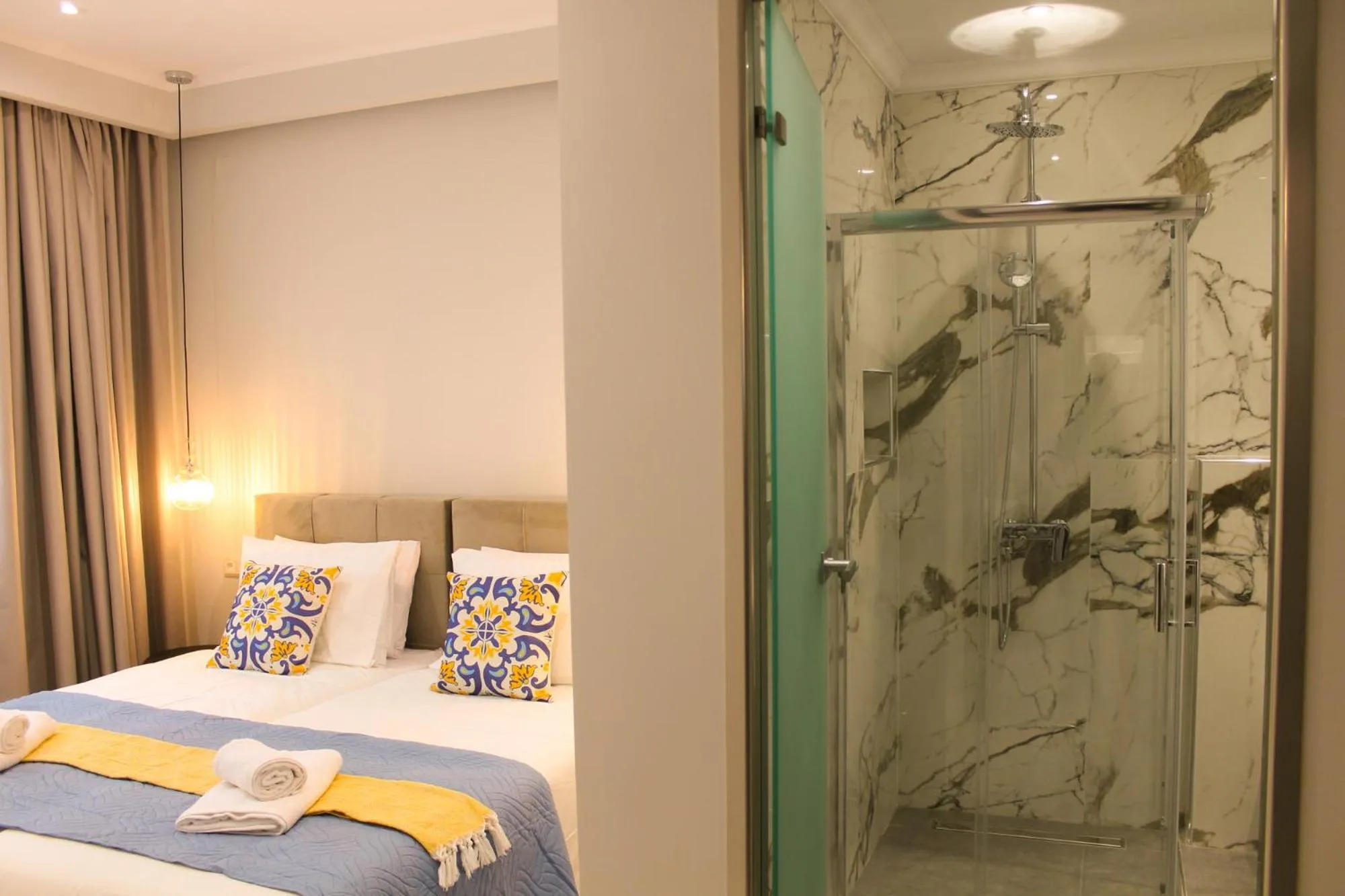 Shower, Bed in Pelagia Apartment by Kormaris