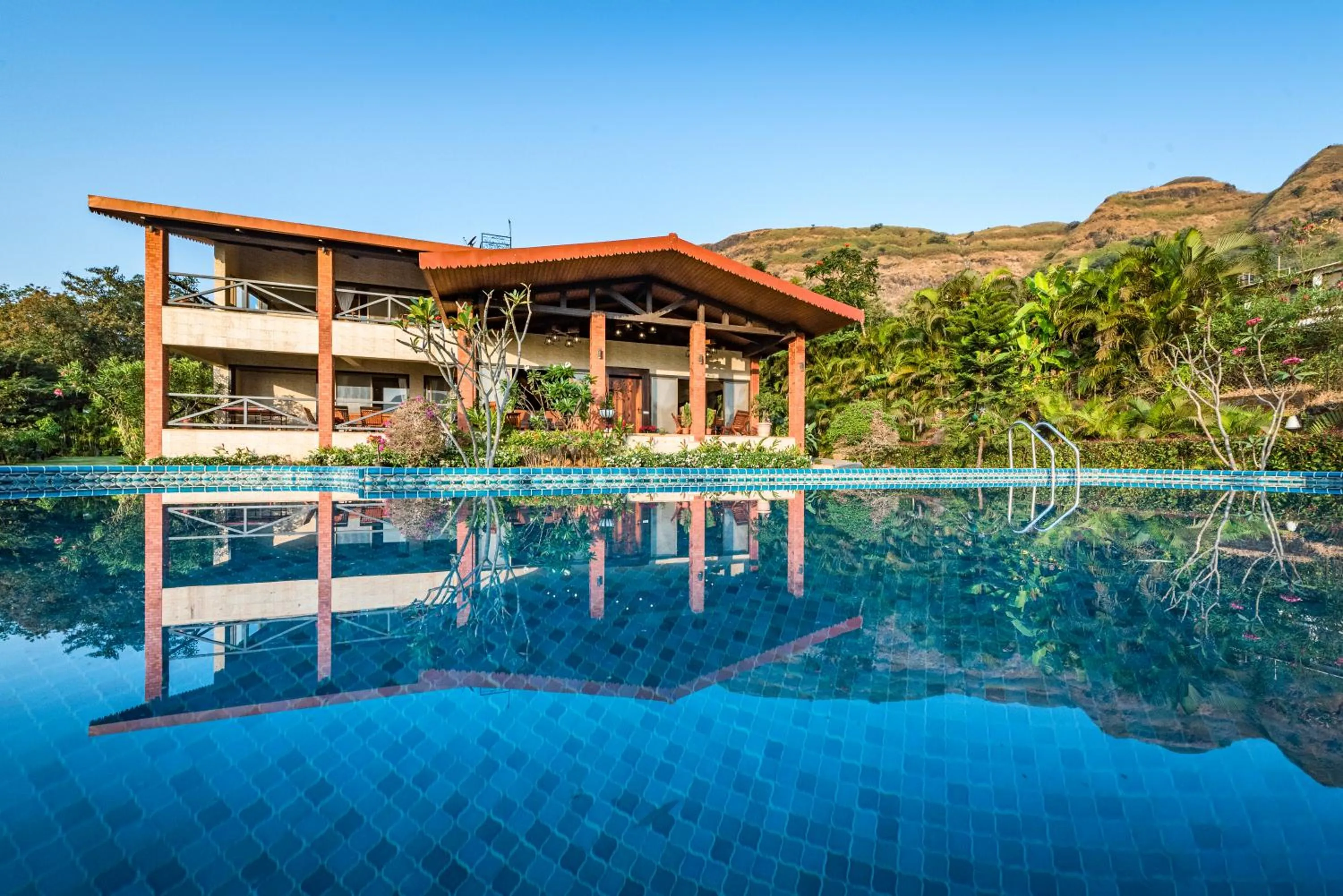 Property building in SaffronStays Althea - 4BR veg-only luxury villa with pool, jacuzzis, gourmet meals and Lohagad-Pawna lake views