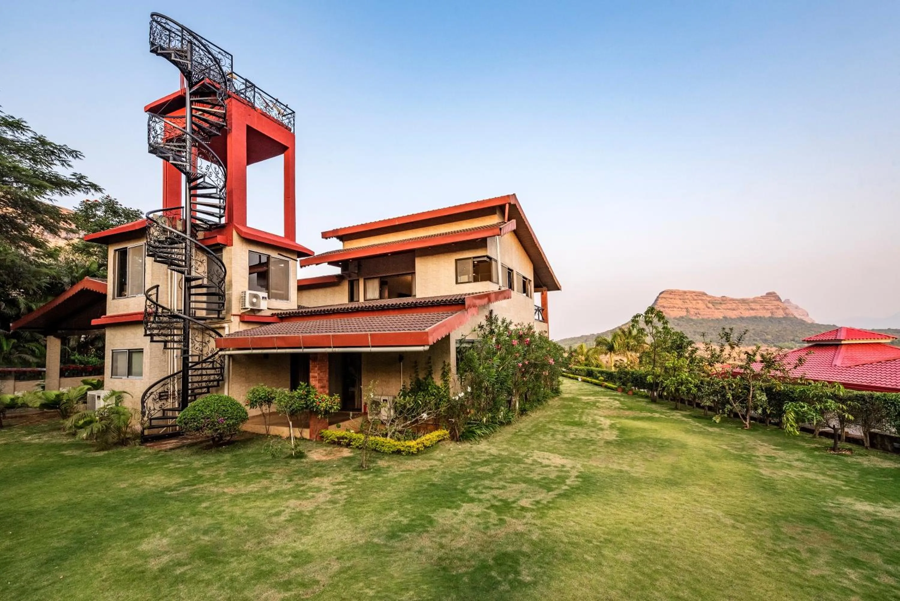 Property building in SaffronStays Althea - 4BR veg-only luxury villa with pool, jacuzzis, gourmet meals and Lohagad-Pawna lake views