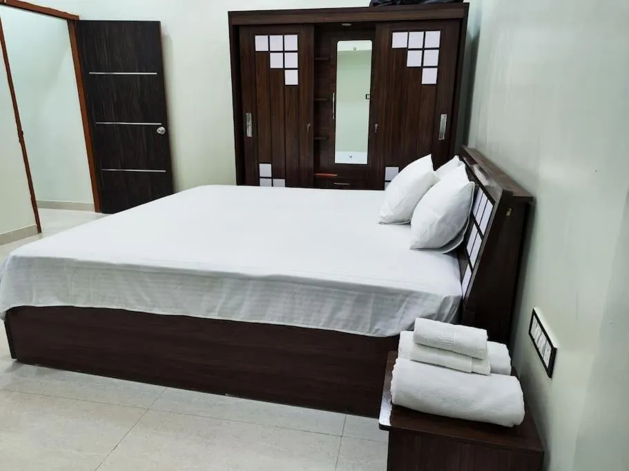 Bed in 1BHK AC Service Apartment 202