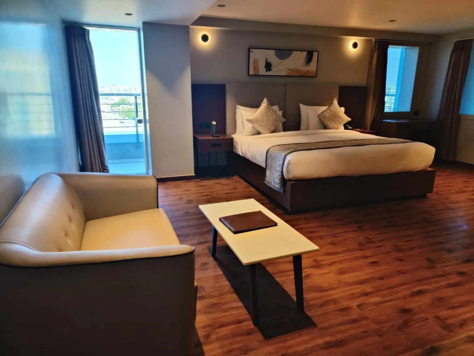 Seating area, Bed in Ramee International Surat