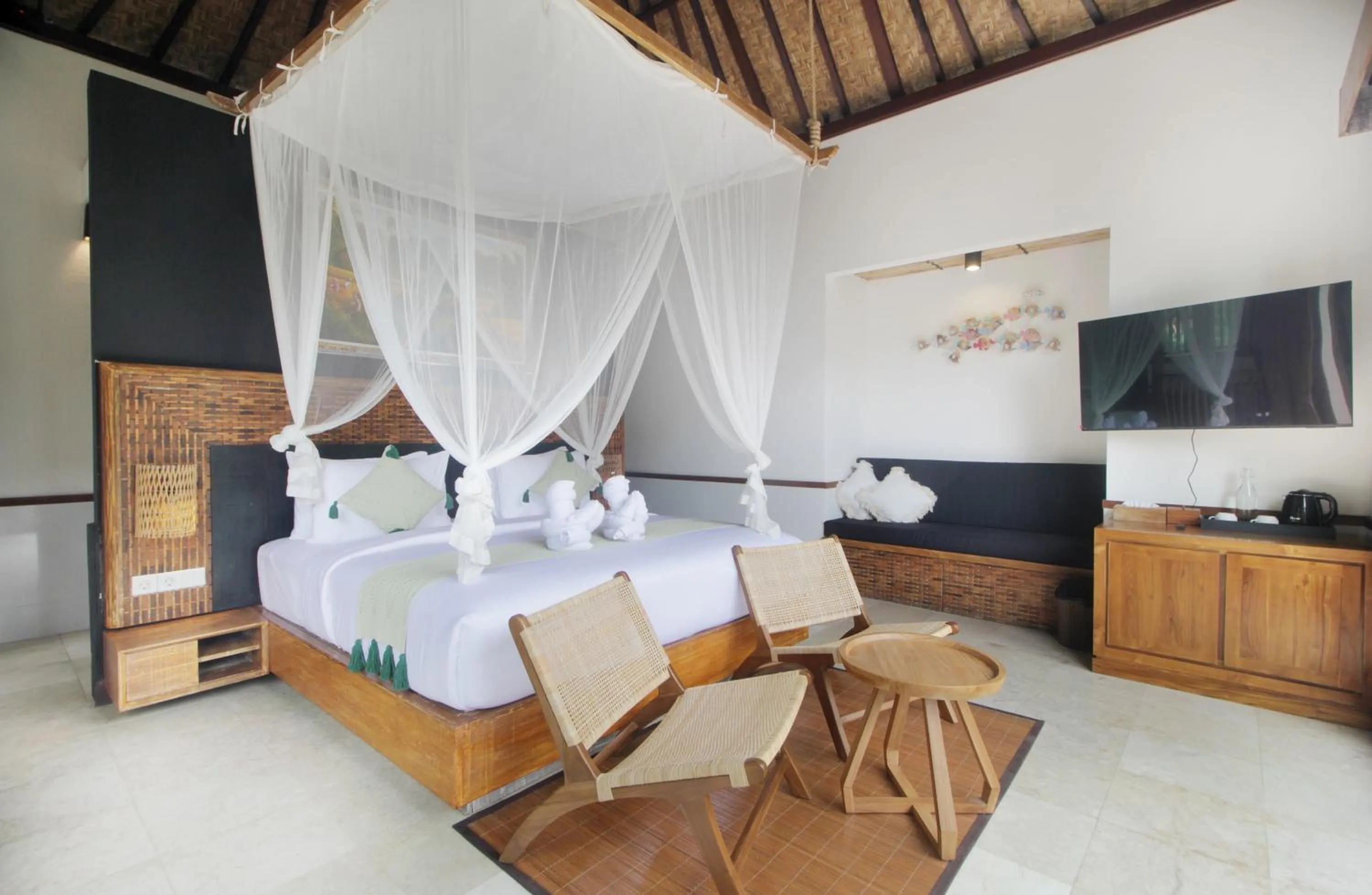 Communal lounge/ TV room, Bed in The Tirta Sari Villas