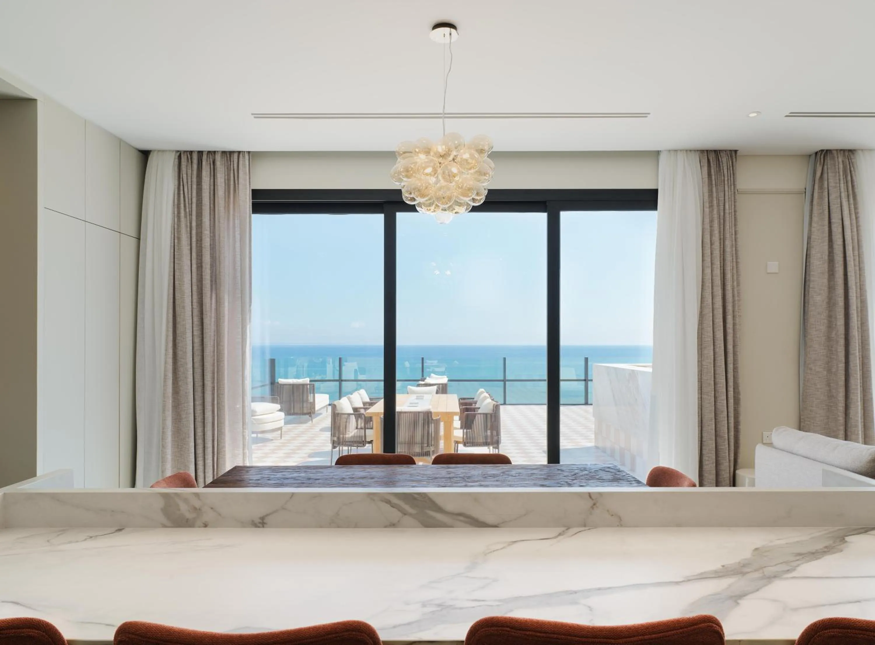 Dining area, Bed in LIV Mackenzie Beach Suites Larnaca ADULTS ONLY