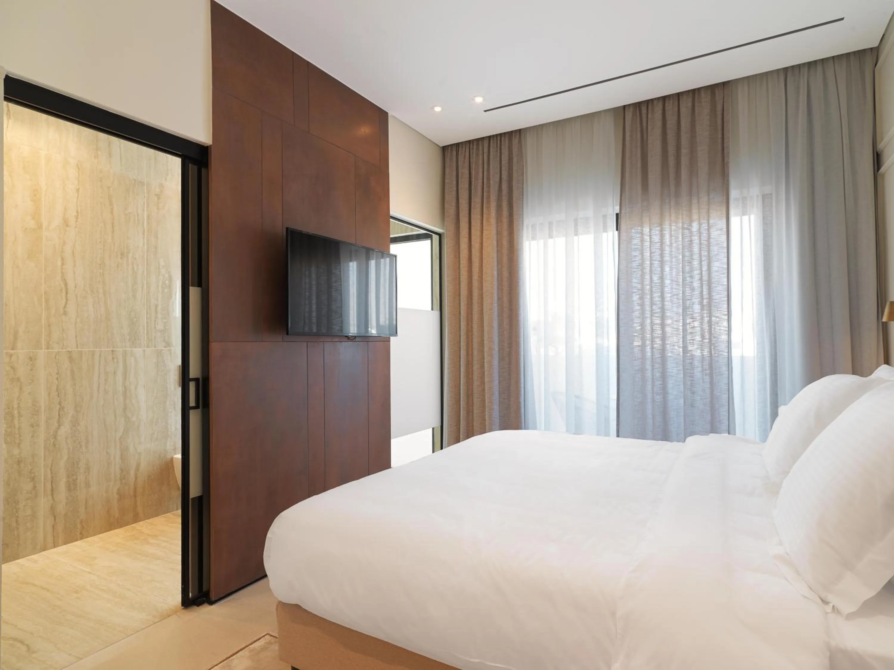 Bathroom, Bed in LIV Mackenzie Beach Suites Larnaca ADULTS ONLY