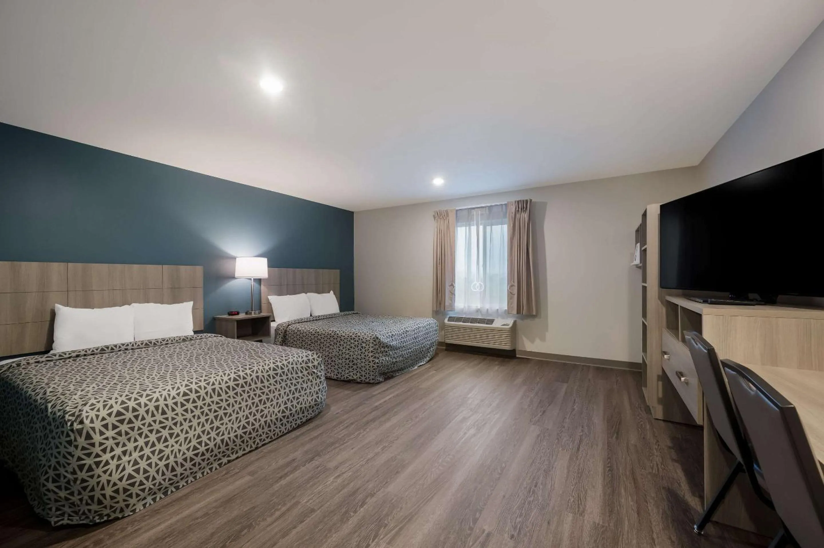 Bed in WoodSpring Suites Wixom - Novi