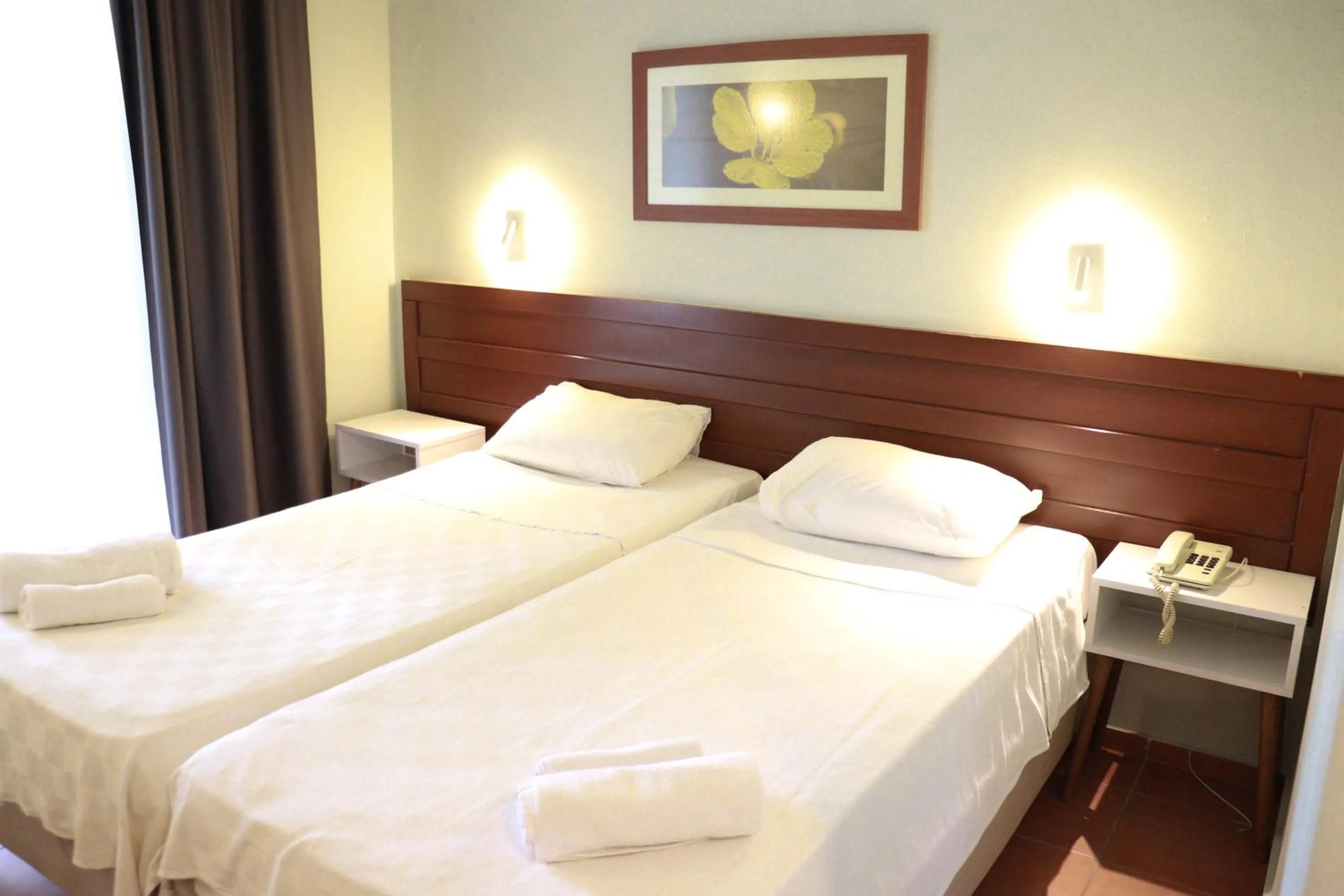 Bed in LEMAS SUITE HOTEL