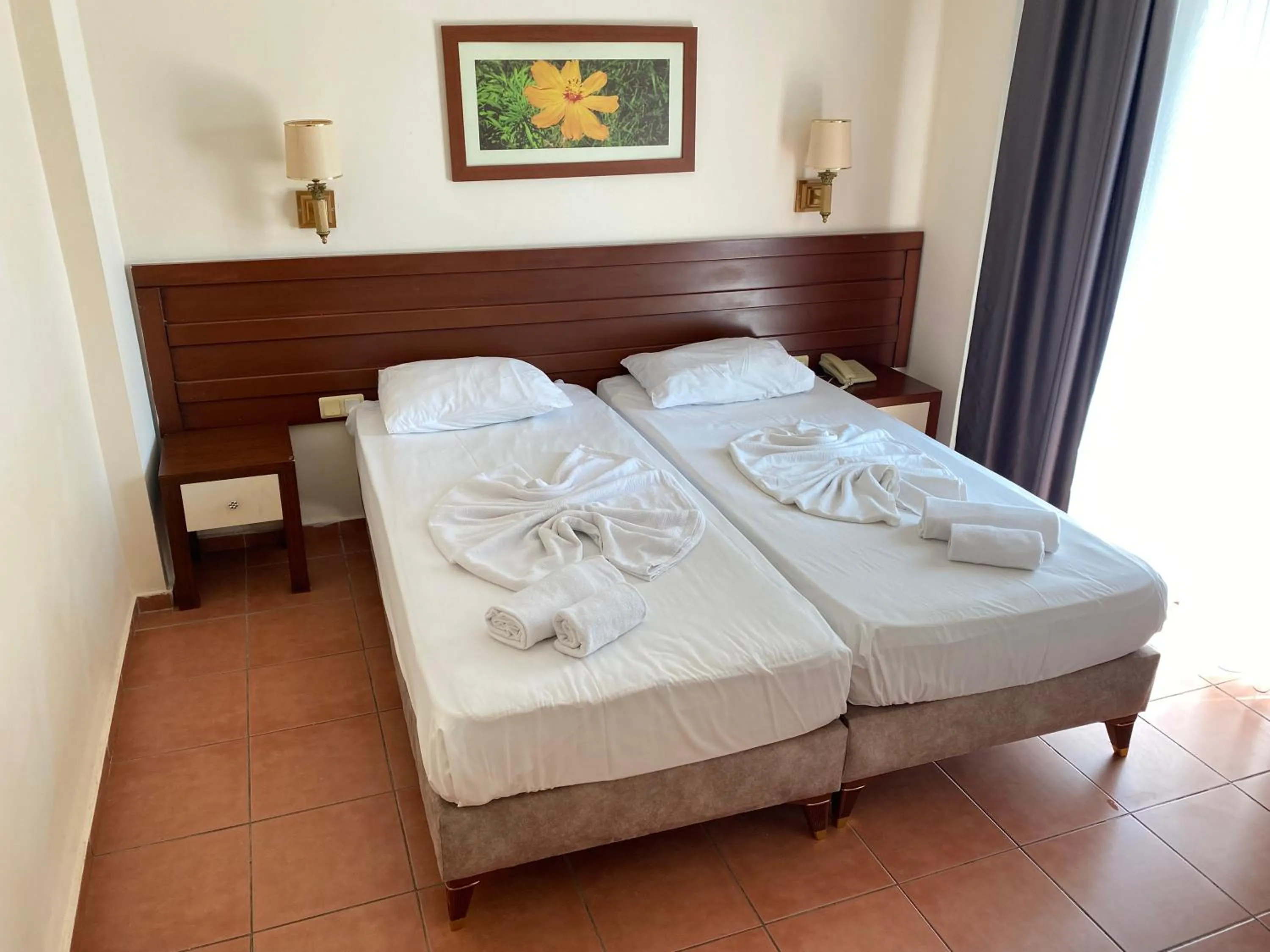 Bed in LEMAS SUITE HOTEL