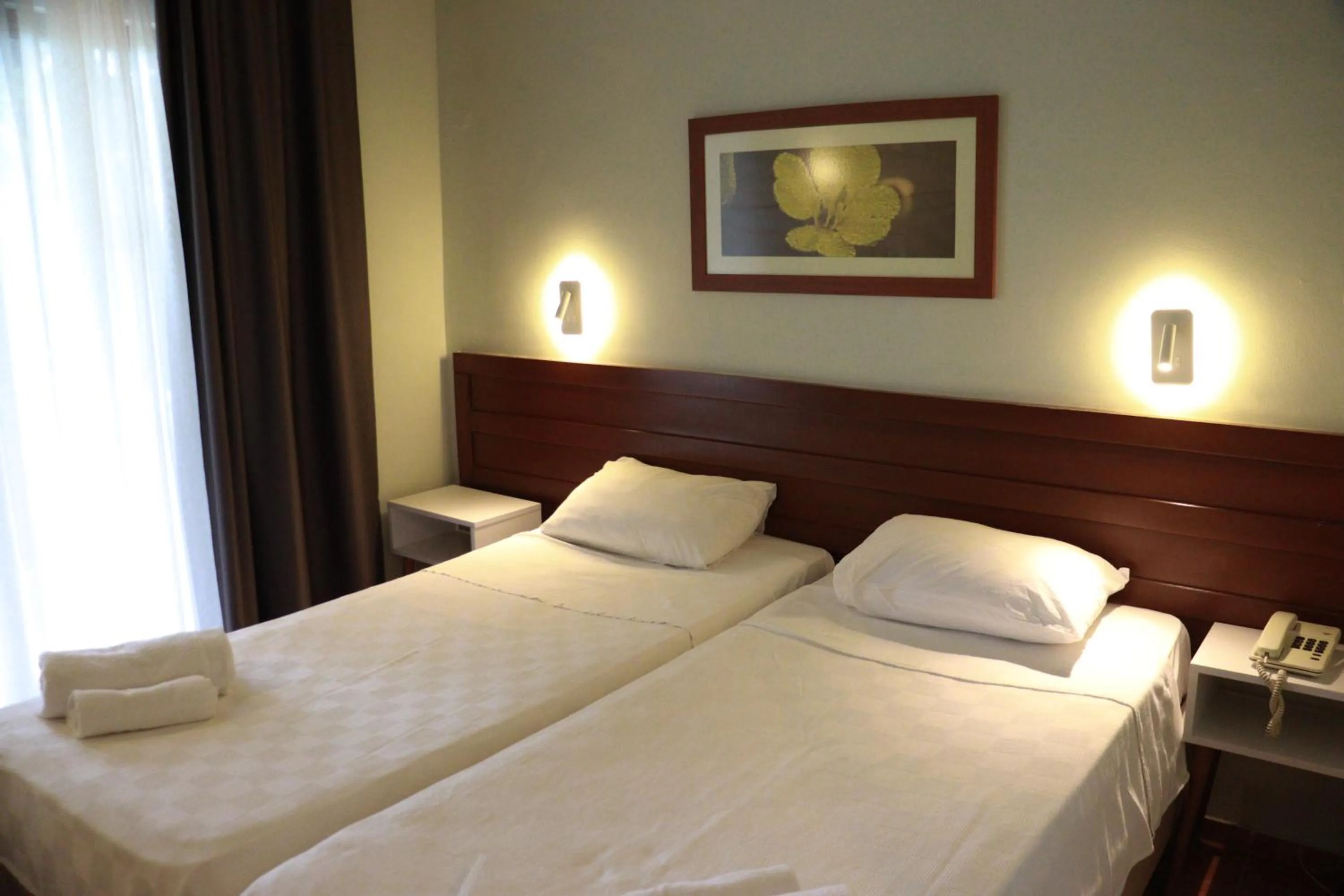 Bed in LEMAS SUITE HOTEL