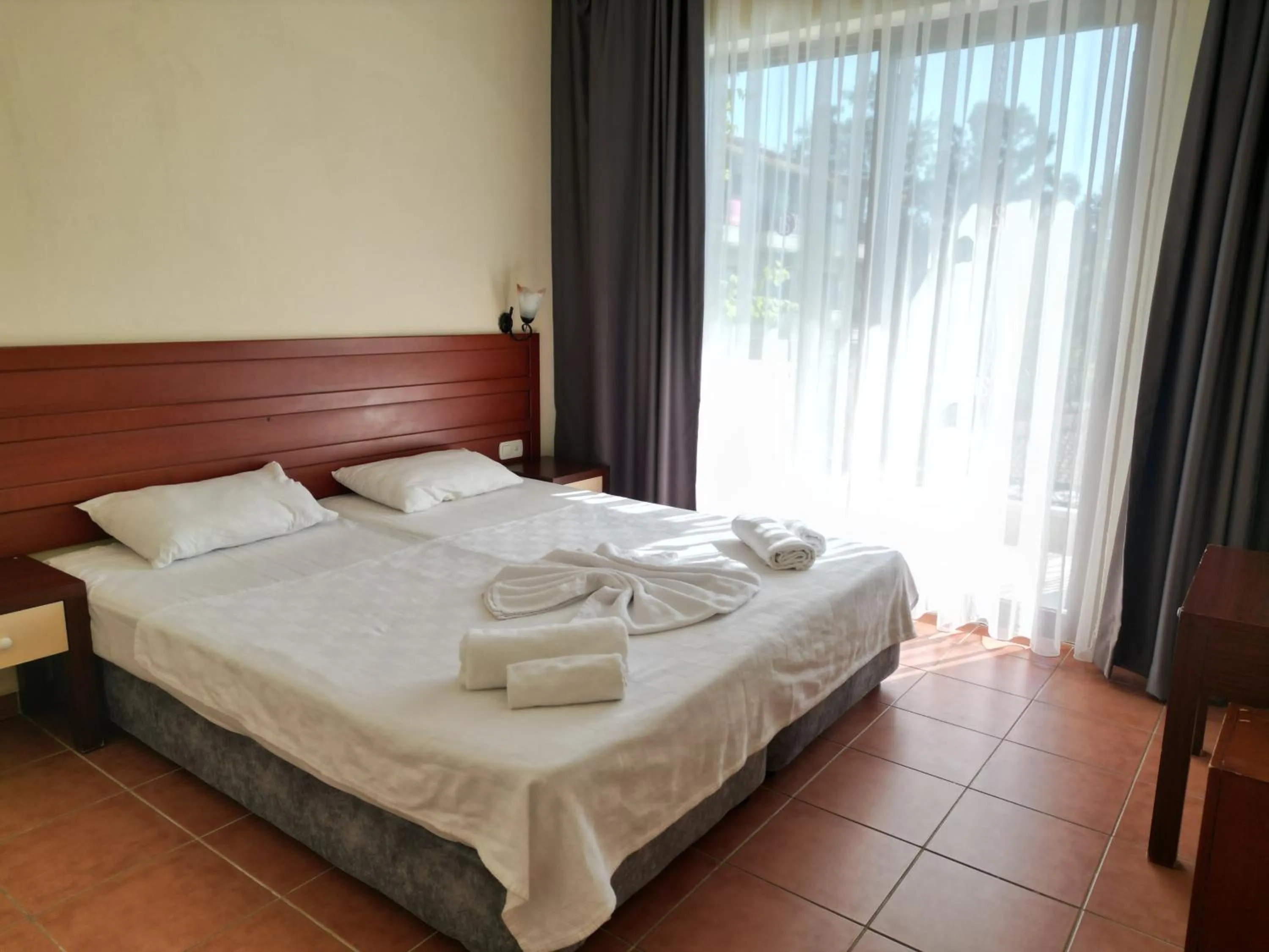 Bed in LEMAS SUITE HOTEL