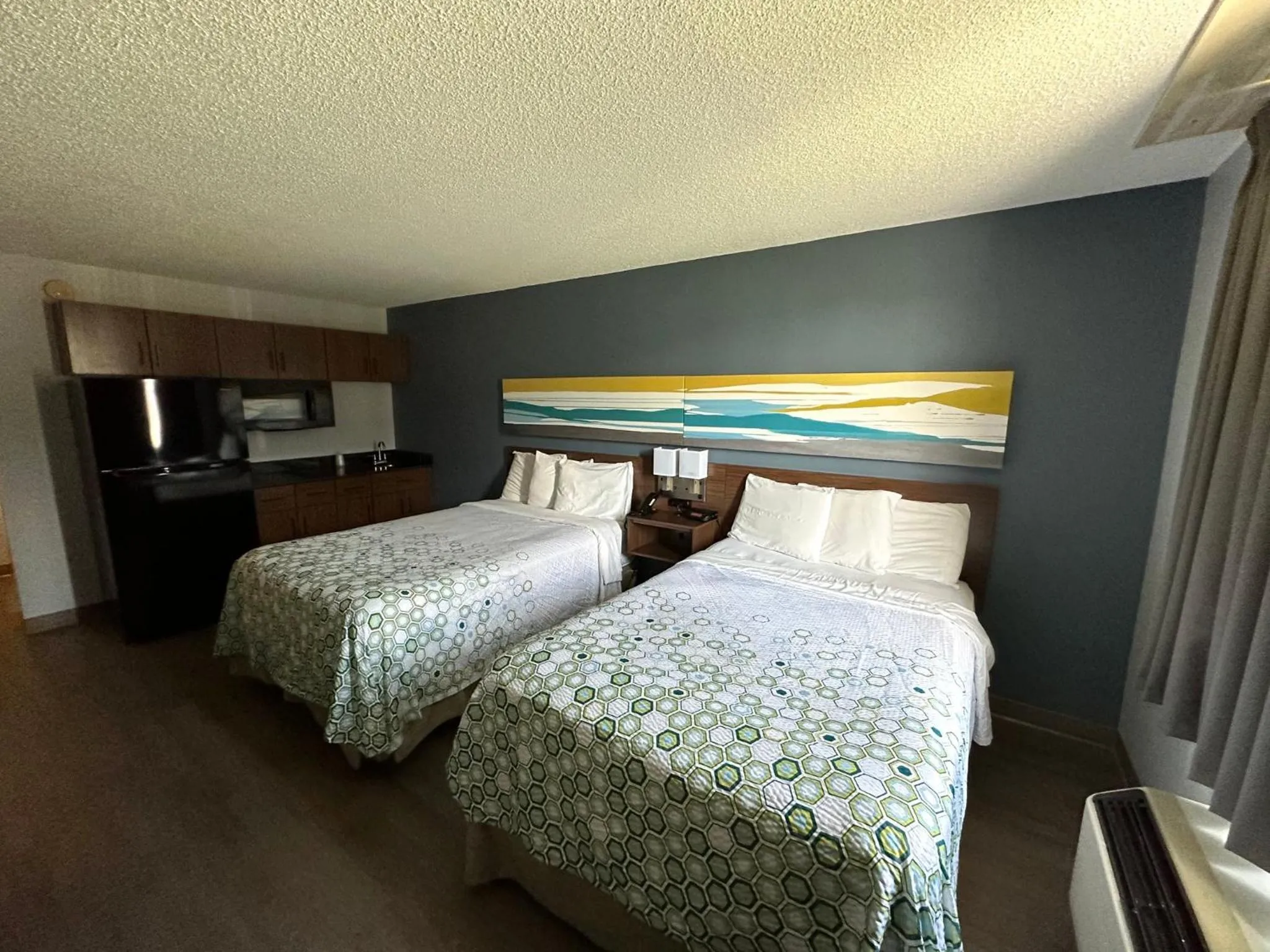 Photo of the whole room, Bed in HomeTowne Studios by Red Roof Painted Post