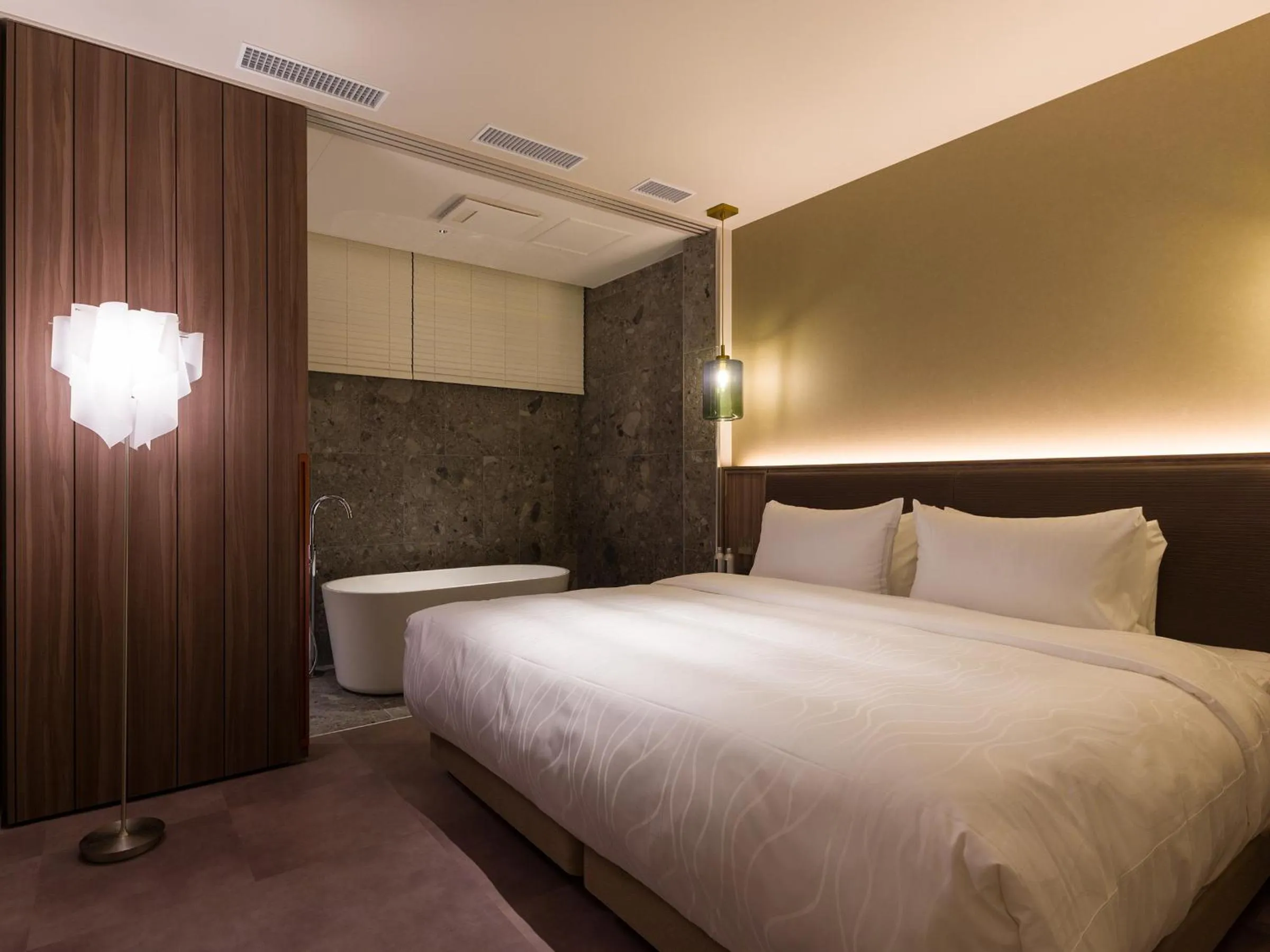 Bed in THE skM TOKYO HOTEL & DINING