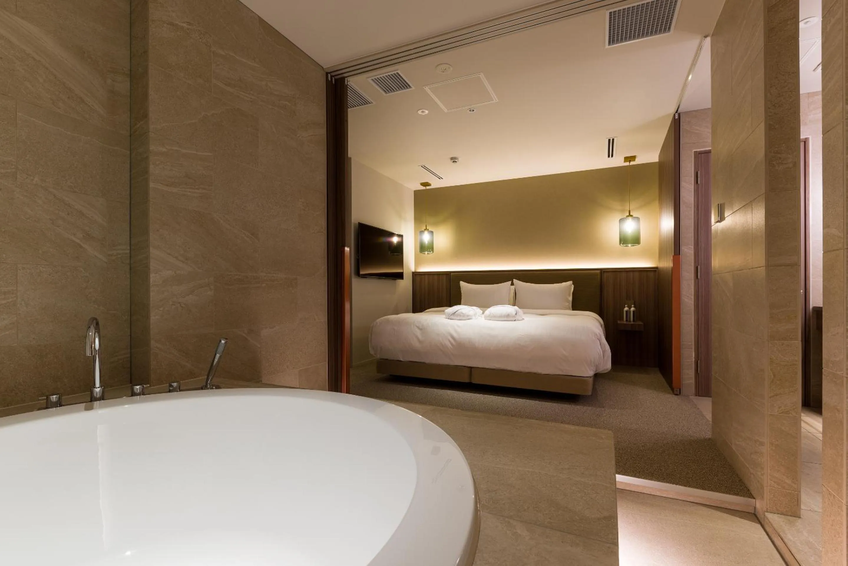 Bed in THE skM TOKYO HOTEL & DINING