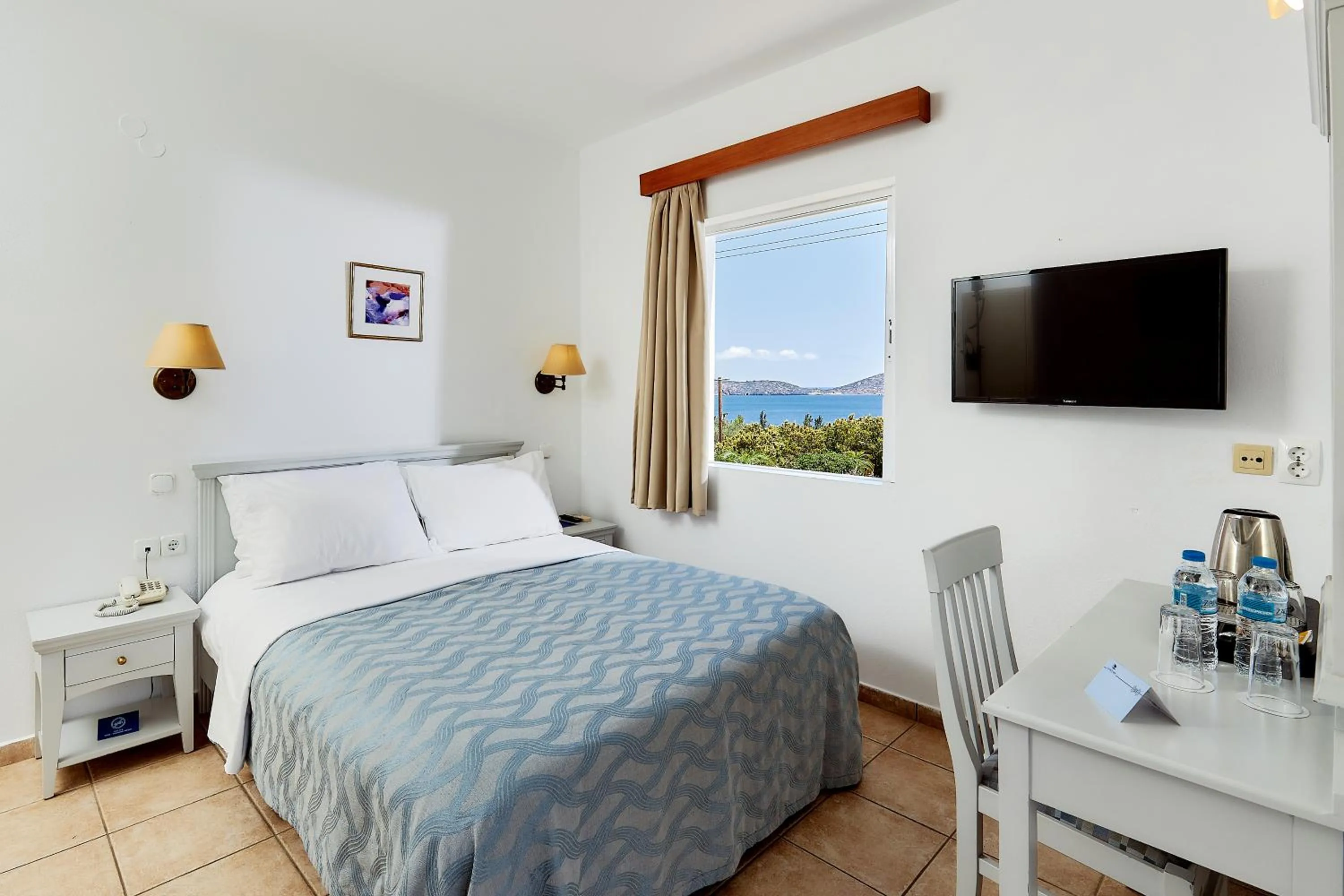 Bed in Elounda Ilion Hotel Bungalows