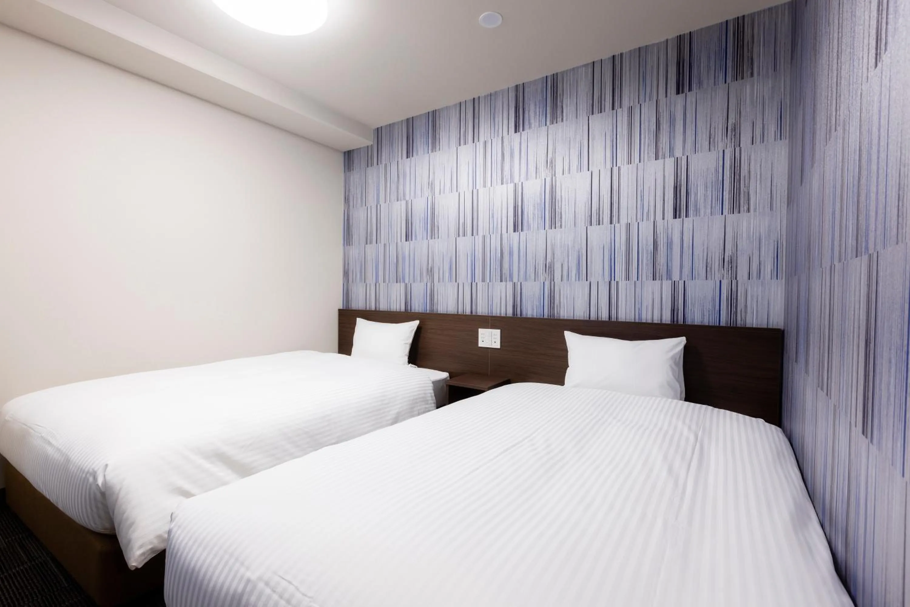 Bed in KOKO HOTEL Shizuoka - formerly Hotel Wing International Shizuoka