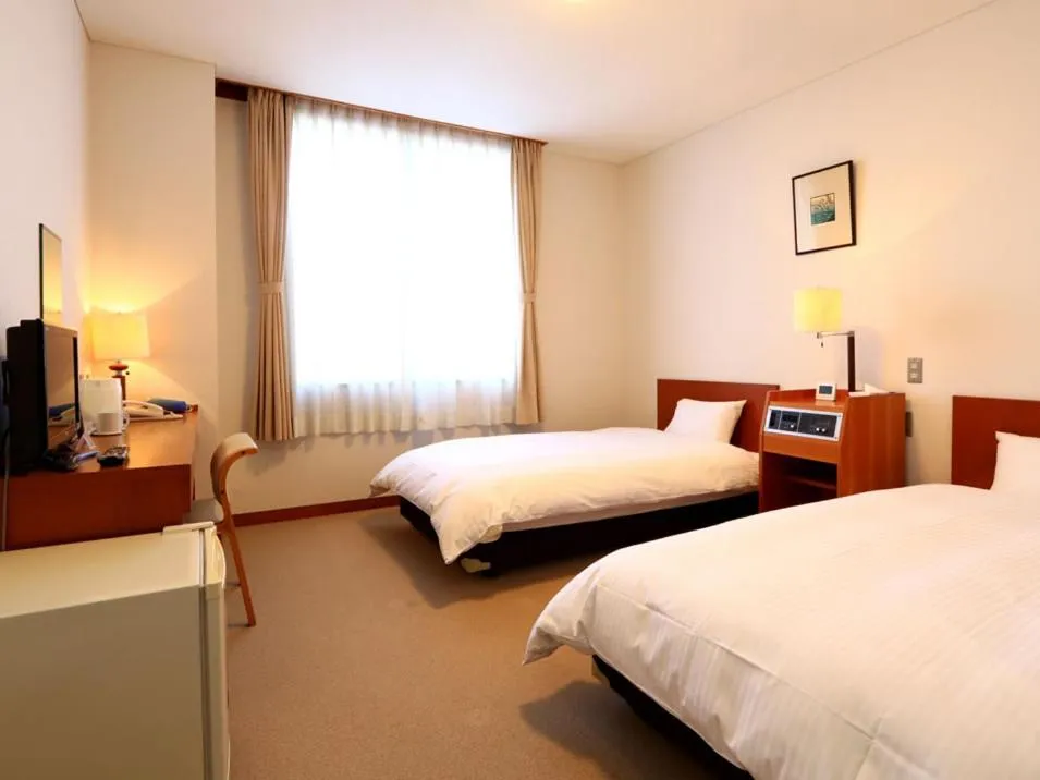 Bed in KANEMITSU CAPITAL HOTEL