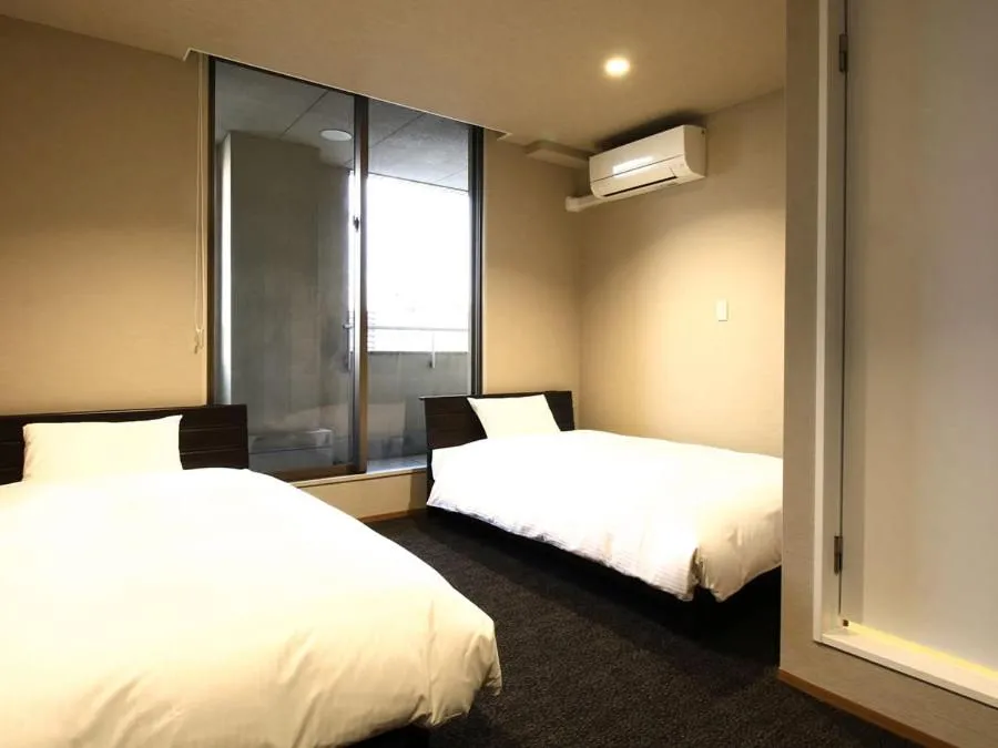 Bed in KANEMITSU CAPITAL HOTEL