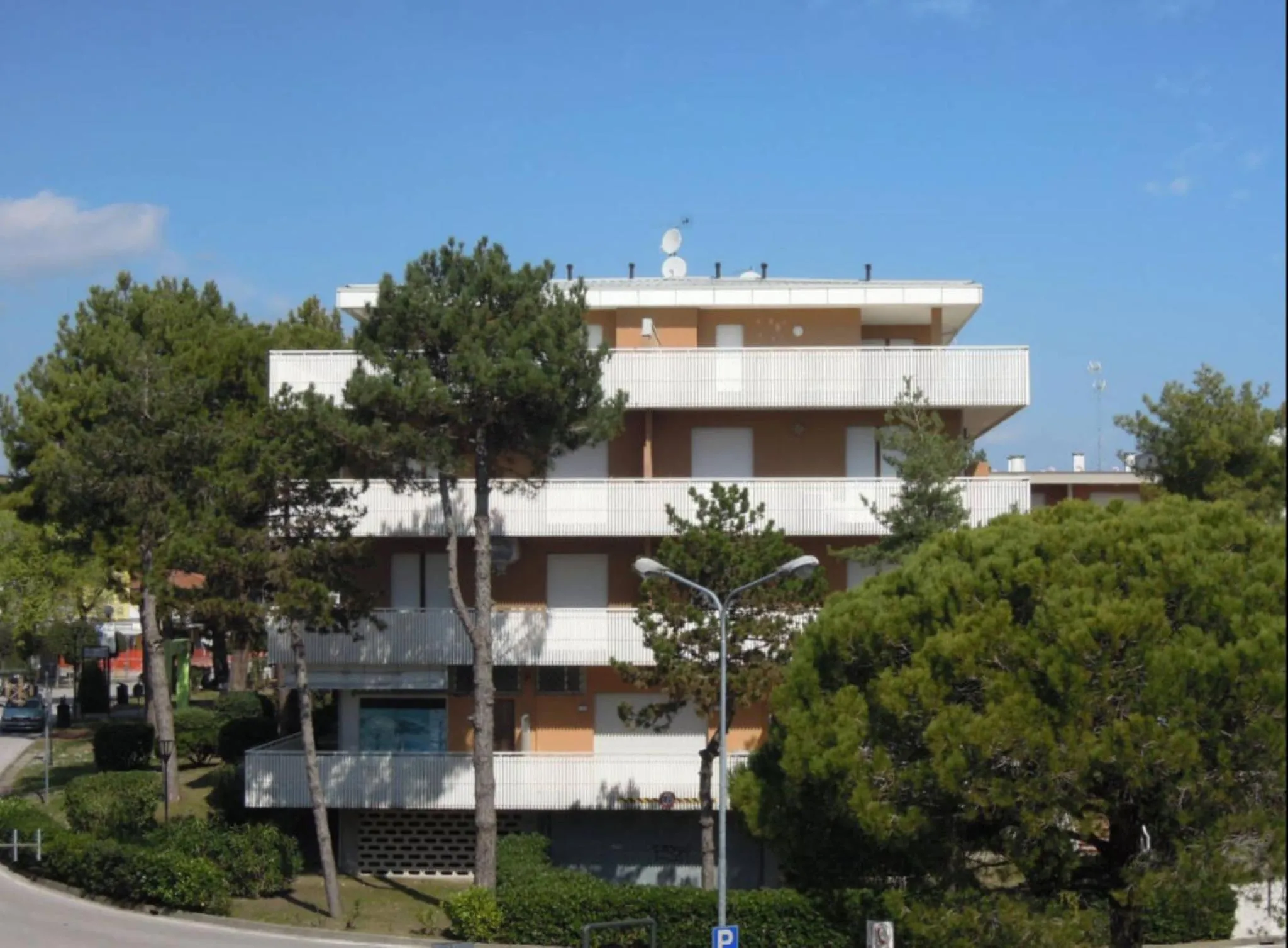 Property building in Family apartment steps from Pluto Beach