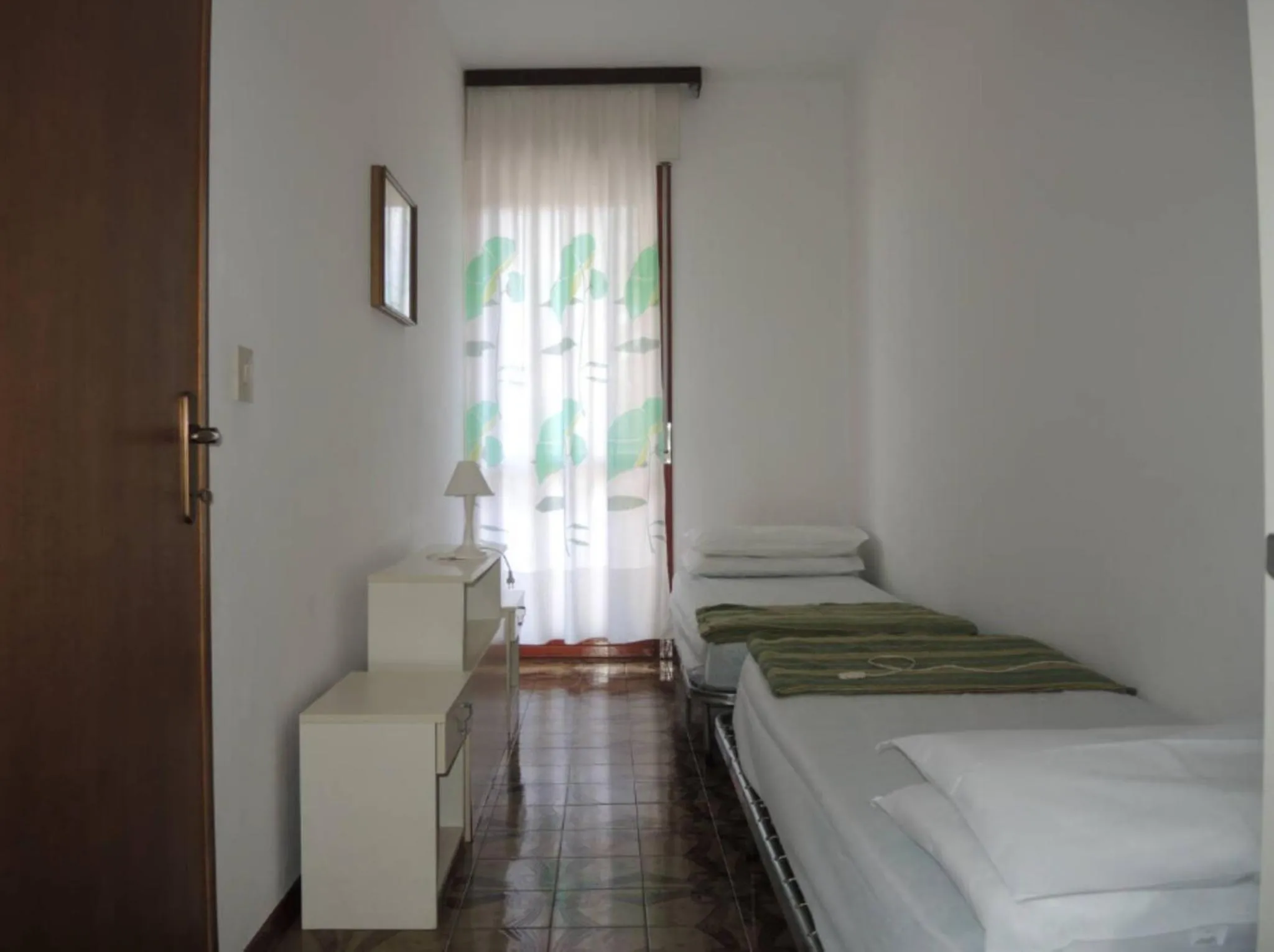 Bed in Family apartment steps from Pluto Beach