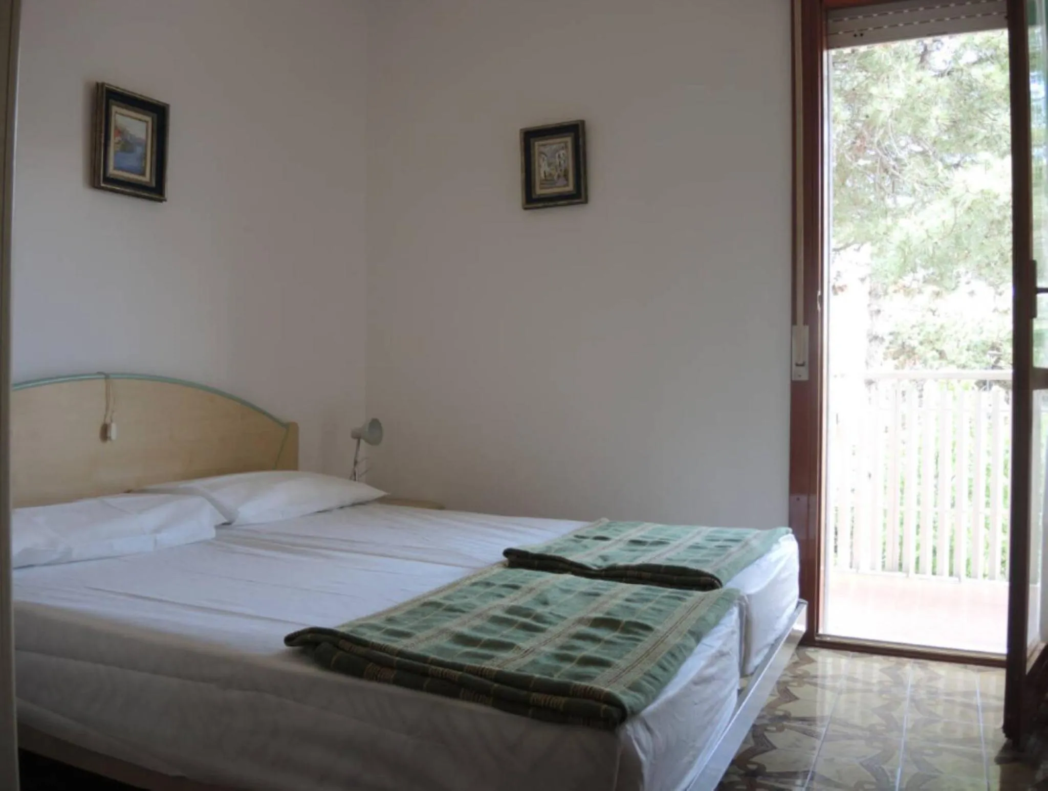 Bed in Family apartment steps from Pluto Beach