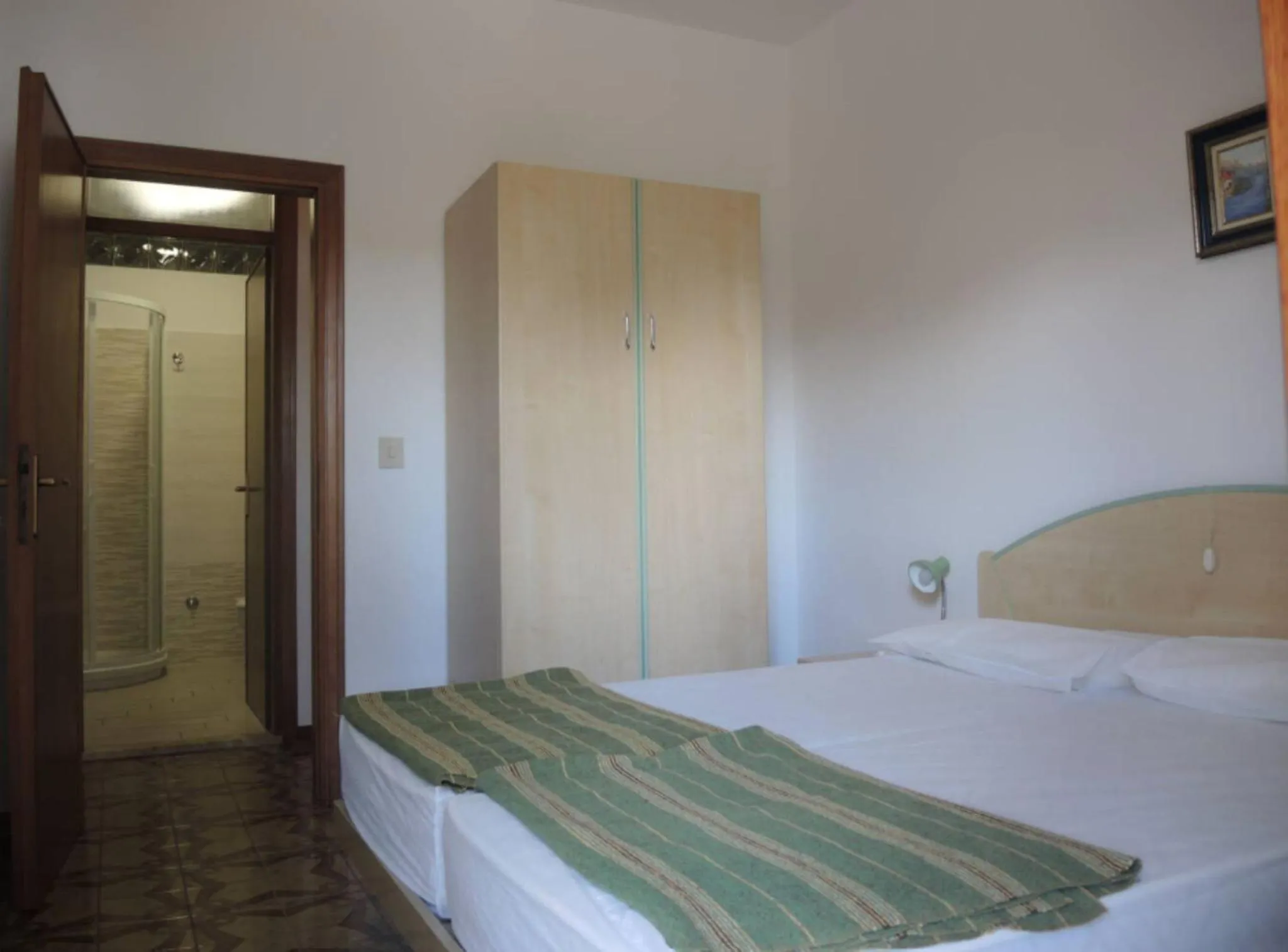 Bed in Family apartment steps from Pluto Beach