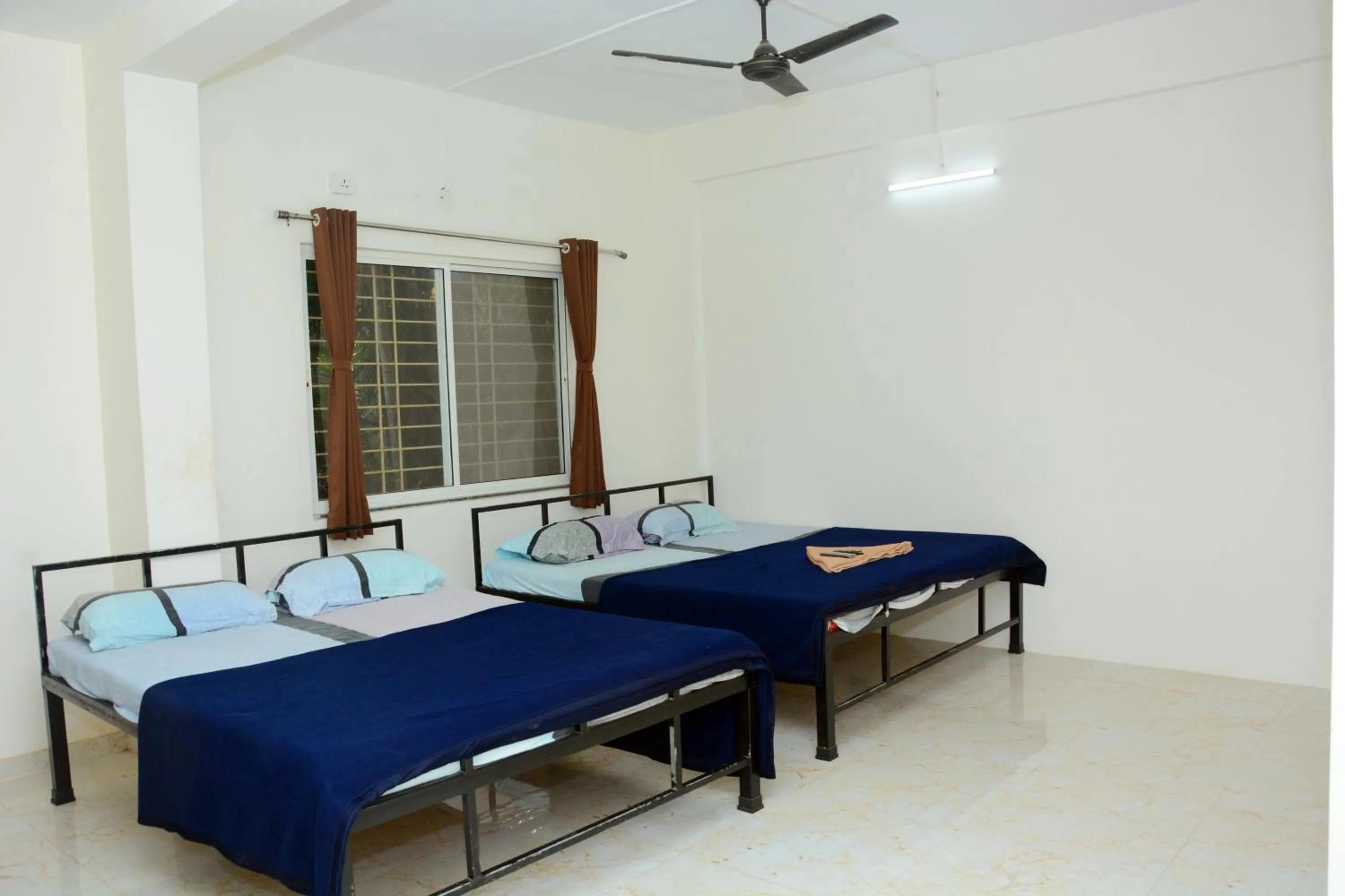 Photo of the whole room, Bed in Shree Swami Samarth Resort