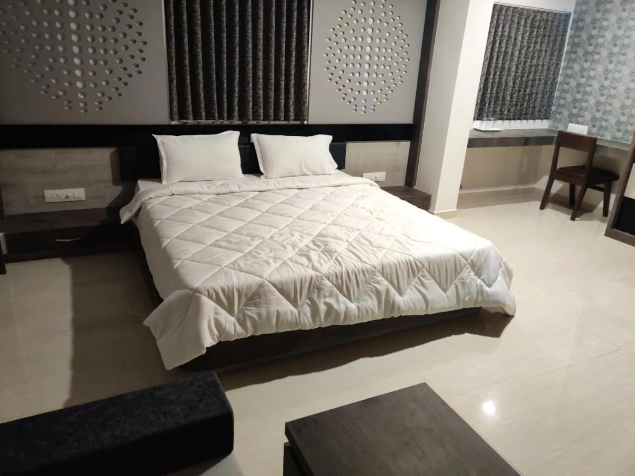 Bed in The Grand Takshak Hotel