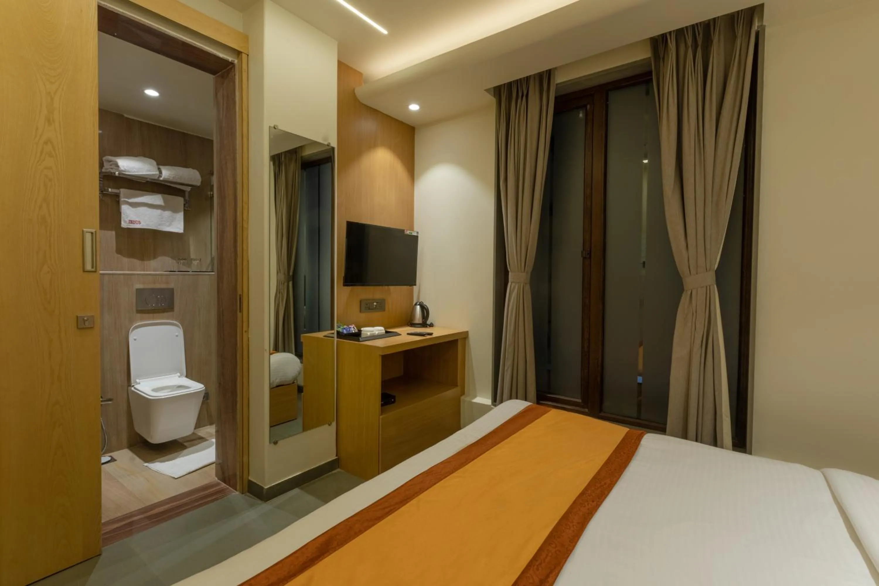 Toilet, Bed in Indus Suites